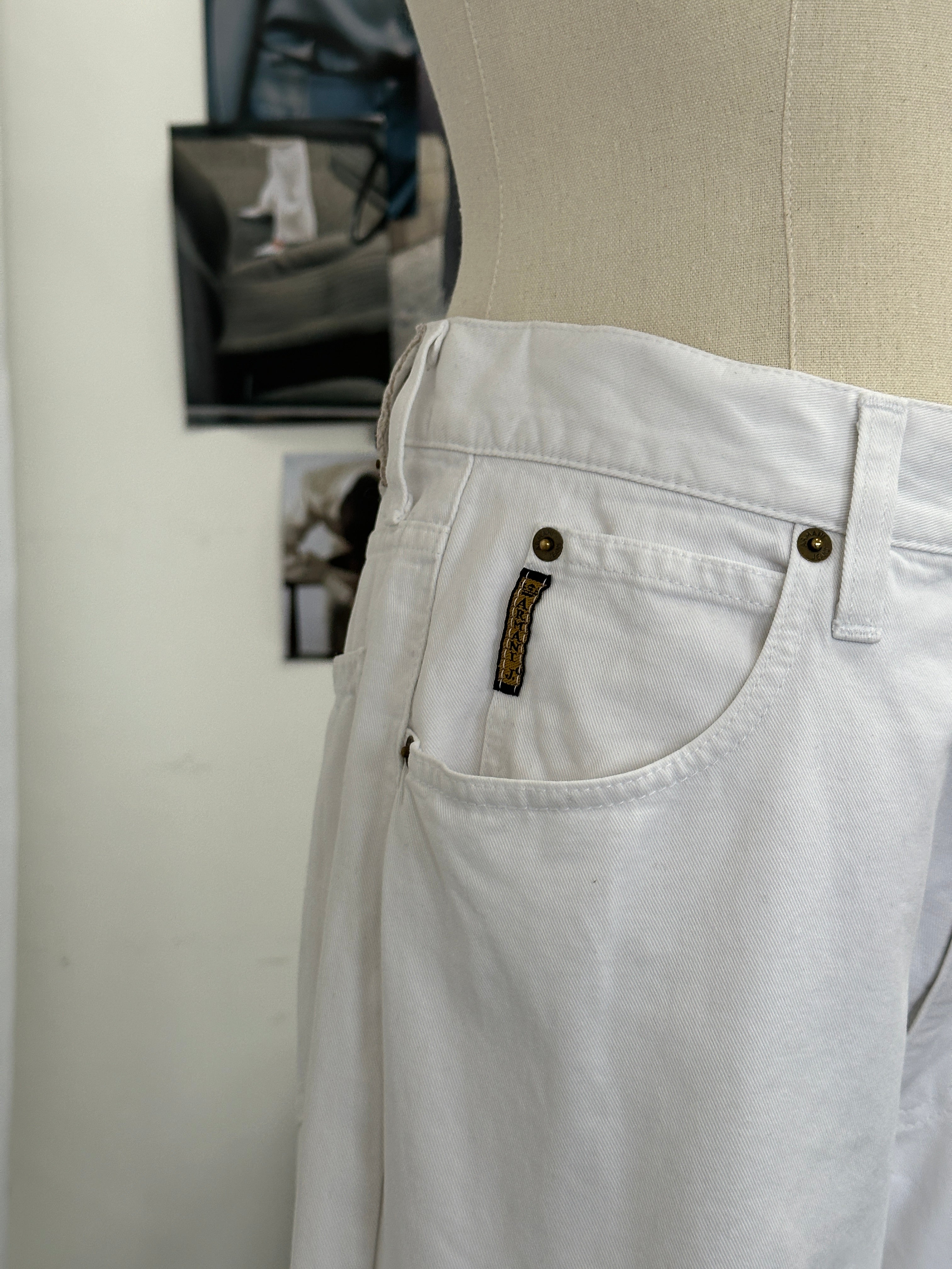 Armani Jeans 1990s straight-leg denim jeans in W28 laid flat, showing classic blue wash and clean design.