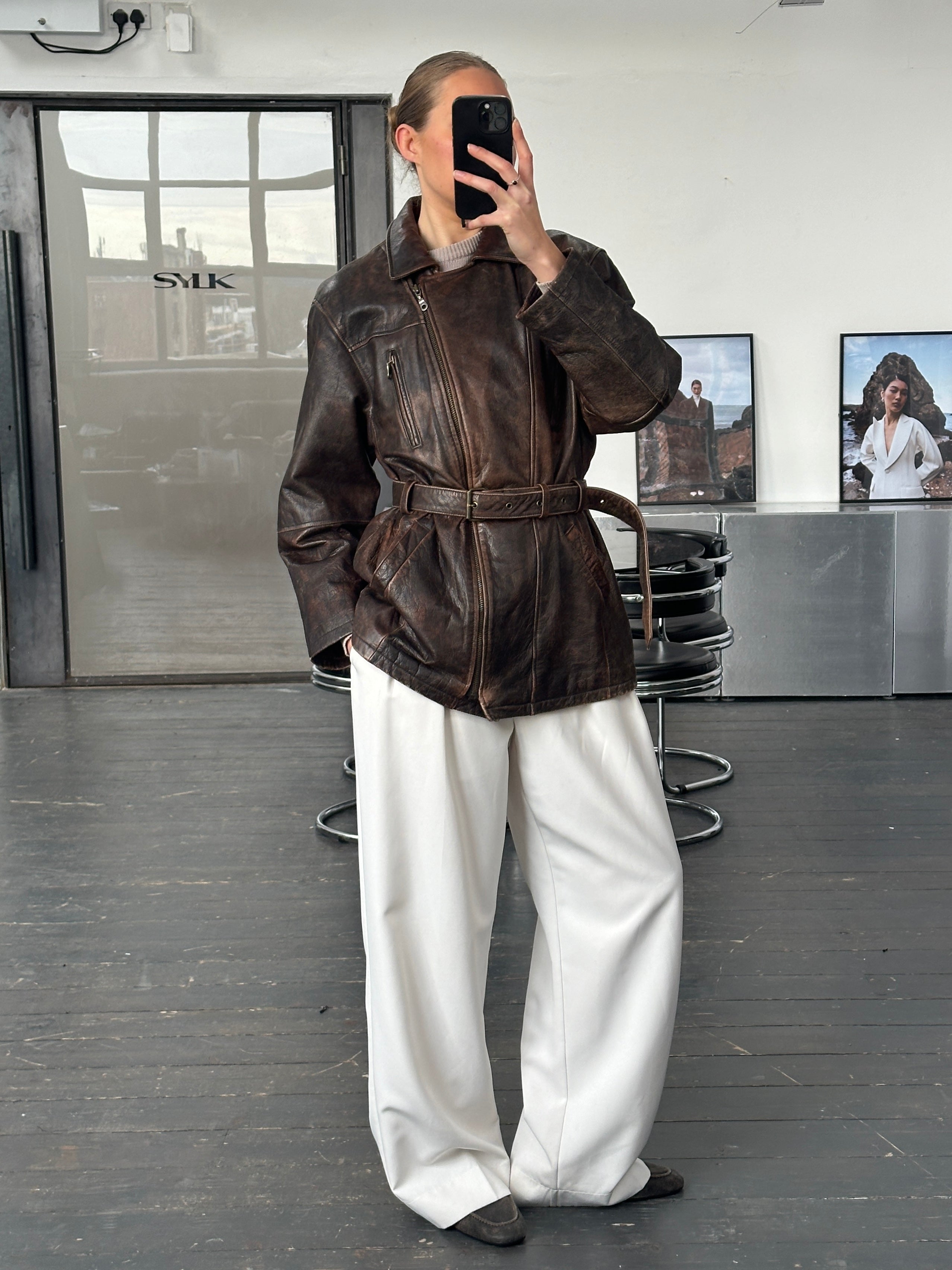 Vintage 1980s belted leather jacket in aged brown leather, featuring classic design and vintage styling, size large.