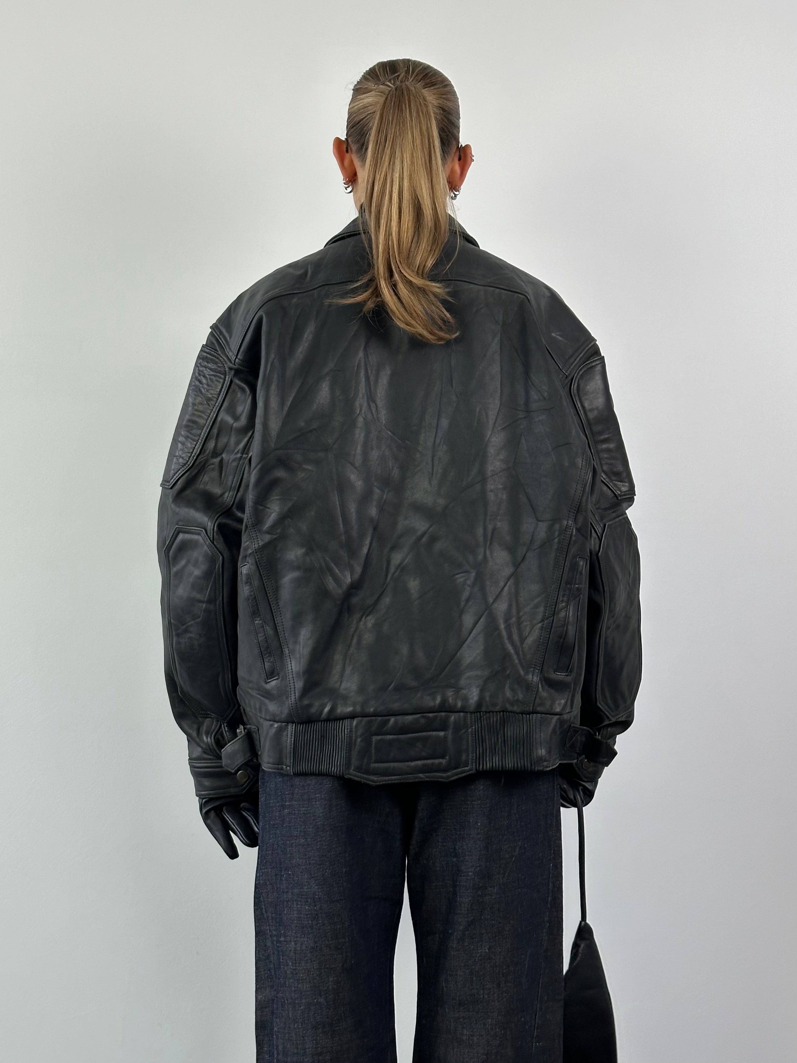 Vintage leather jacket in XL size, featuring classic style and premium leather material, displayed on a hanger.