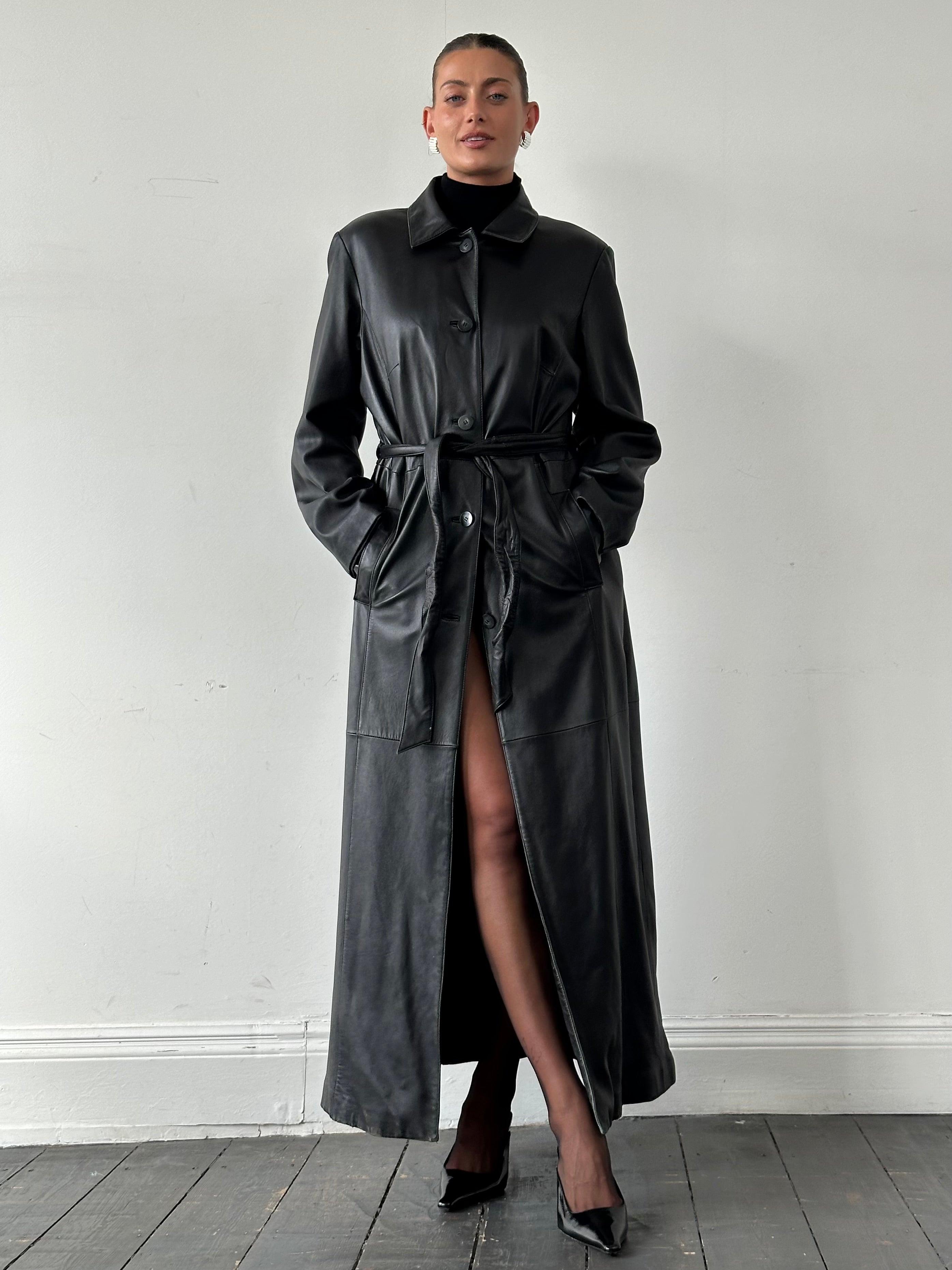 Vintage leather trench coat with a belted waist and floor-length design, styled as an oversized XL leather jacket.