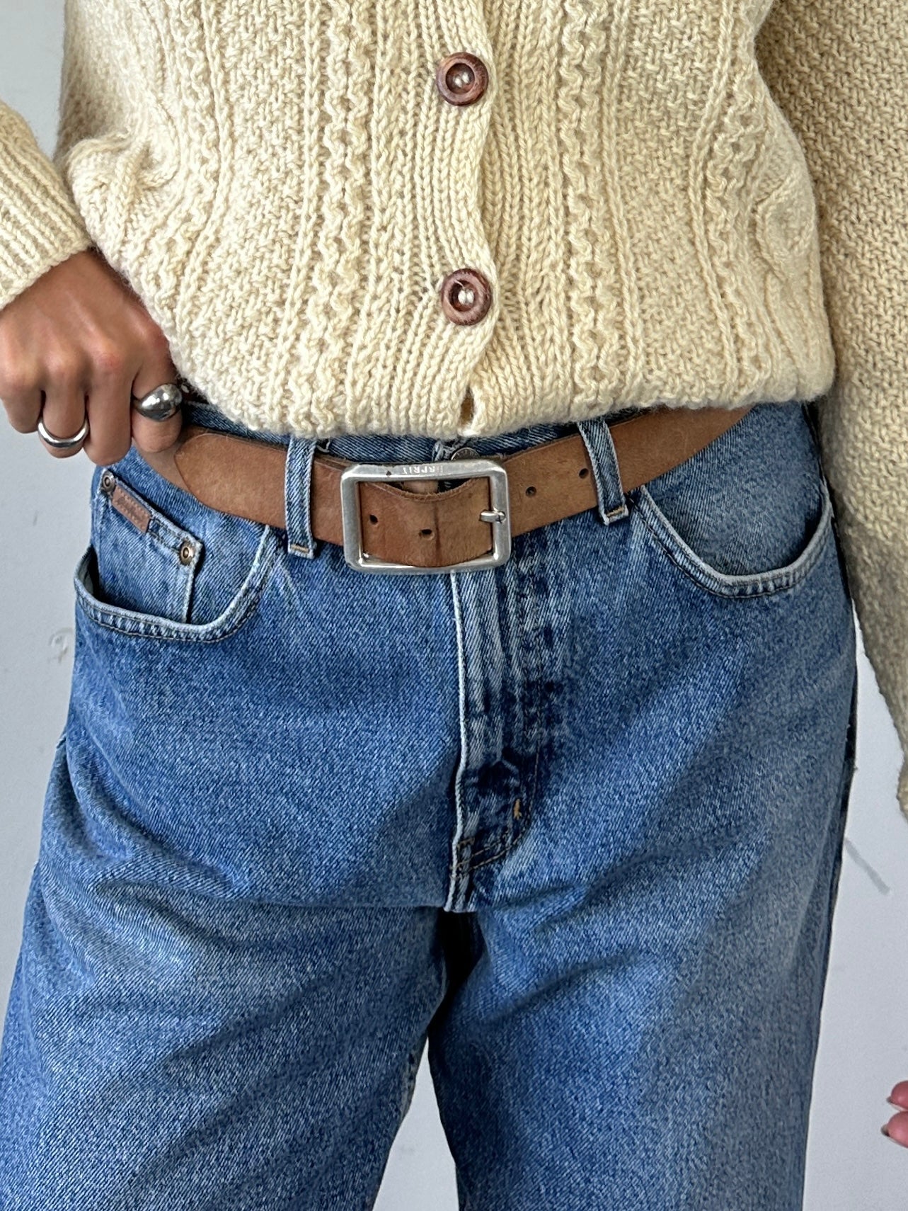 Vintage Leather Belt in size W32-35, featuring classic design and durable leather, displayed laid flat with adjustable holes.