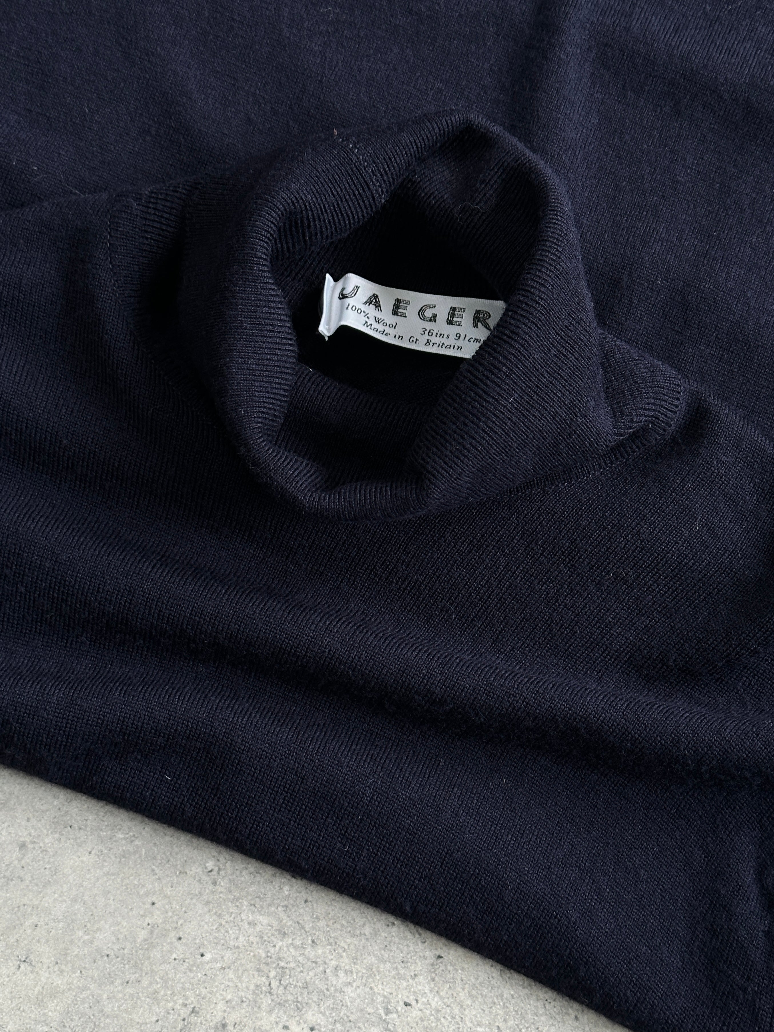 Jaeger pure wool knitted roll neck jumper in size M, featuring a classic design and cozy texture, ideal for cold weather wear