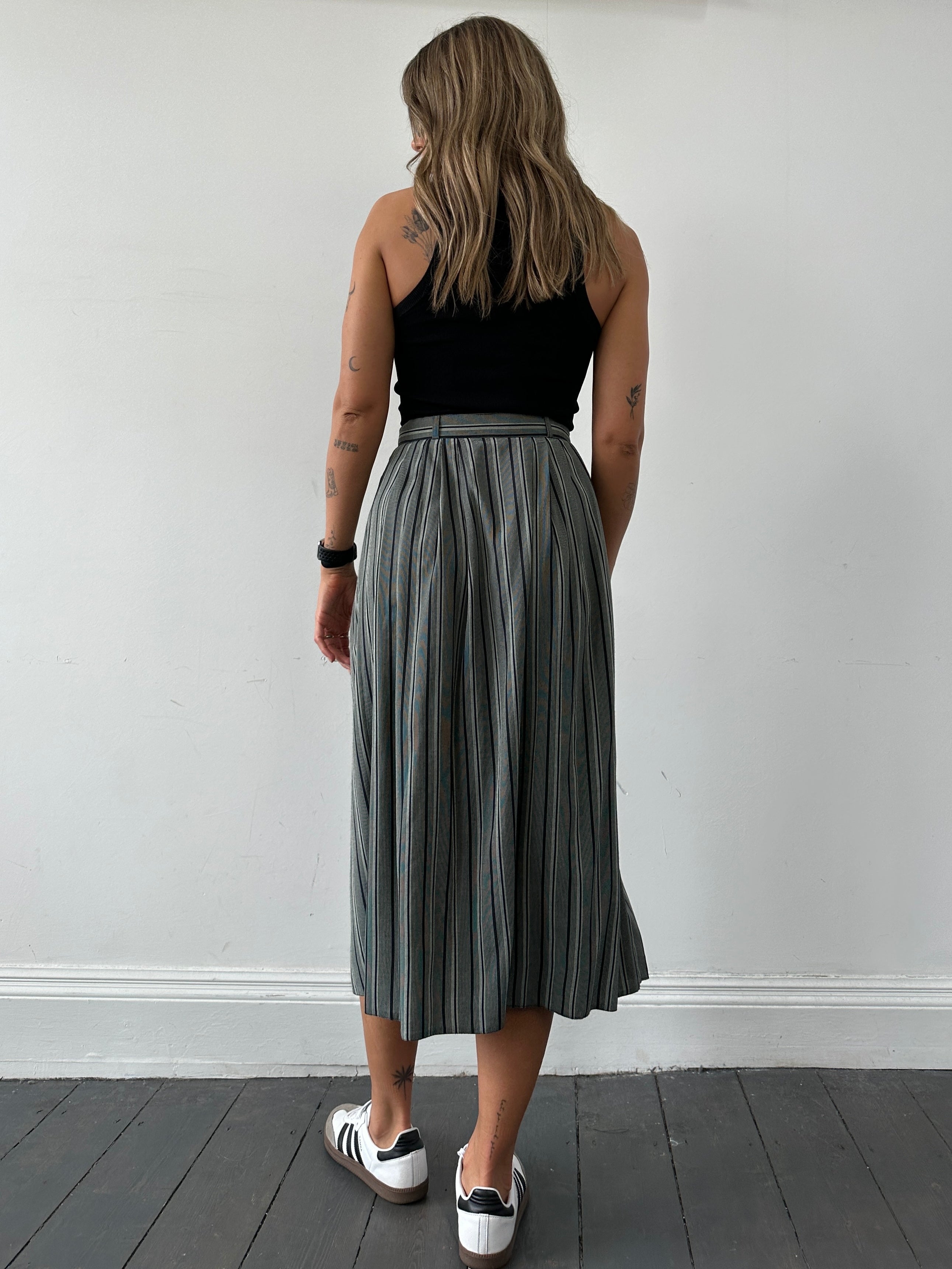 British vintage stripe maxi skirt in W26 size featuring bold, colorful stripes and flowing fabric, perfect for a retro-inspired look.