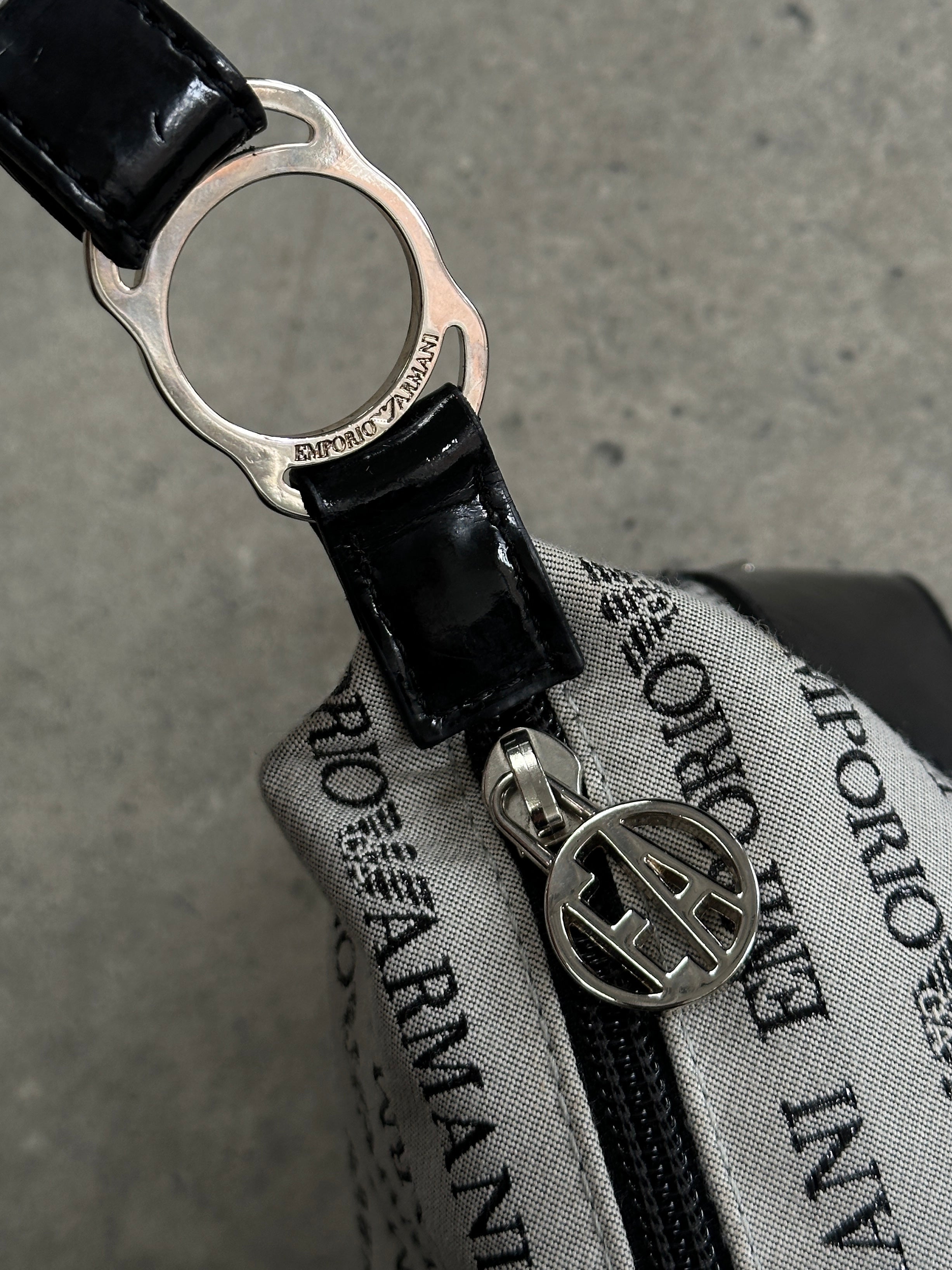 Emporio Armani Monogram Shoulder Bag featuring the signature logo pattern and sleek design, made of high-quality material.