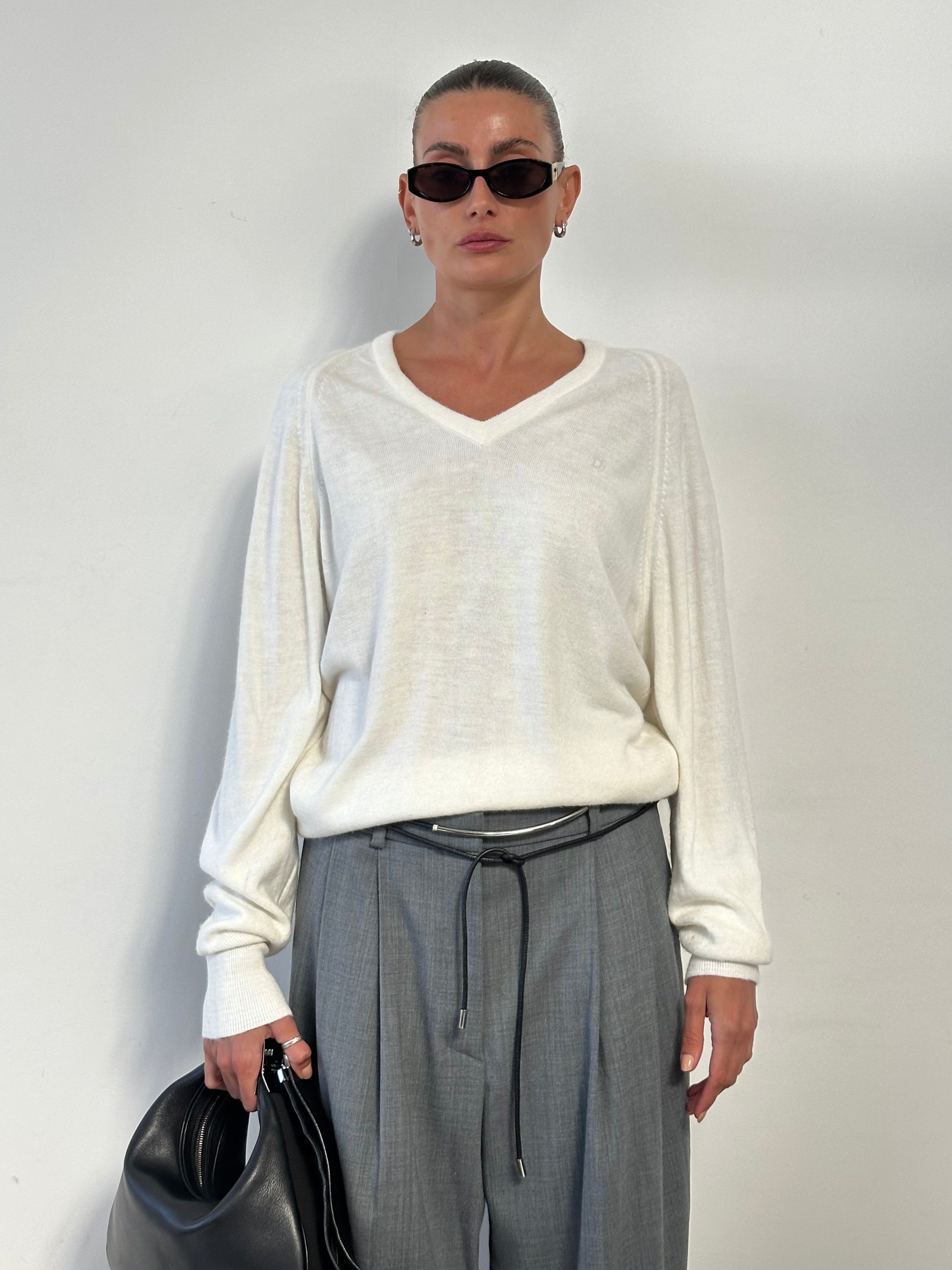 Christian Dior V-neck logo knitted jumper in size L, featuring a stylish V-neck design and iconic Dior branding, soft knit fabric.