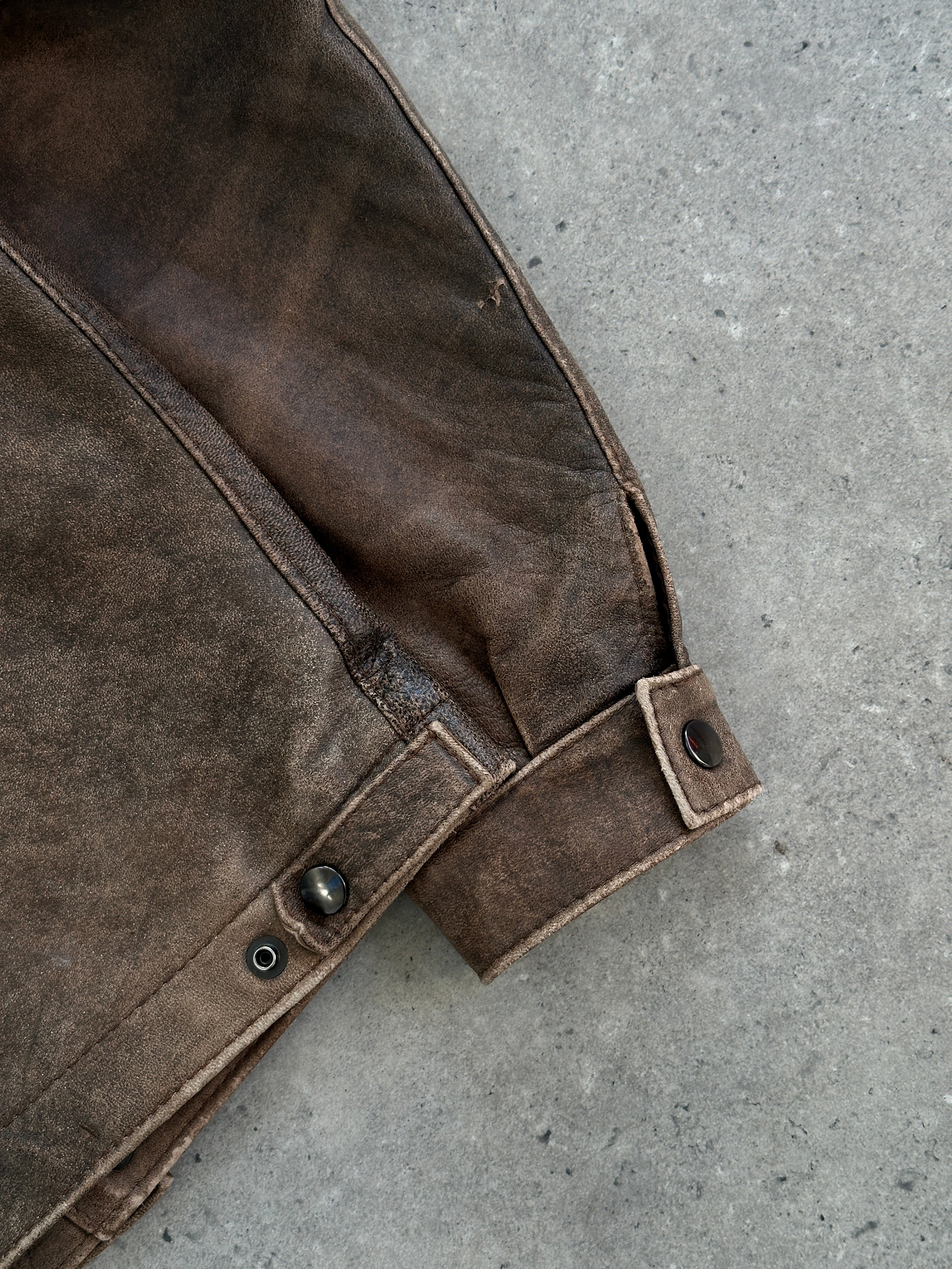 Vintage British aged leather biker jacket in size M/L, rugged style with distressed leather and classic biker design.