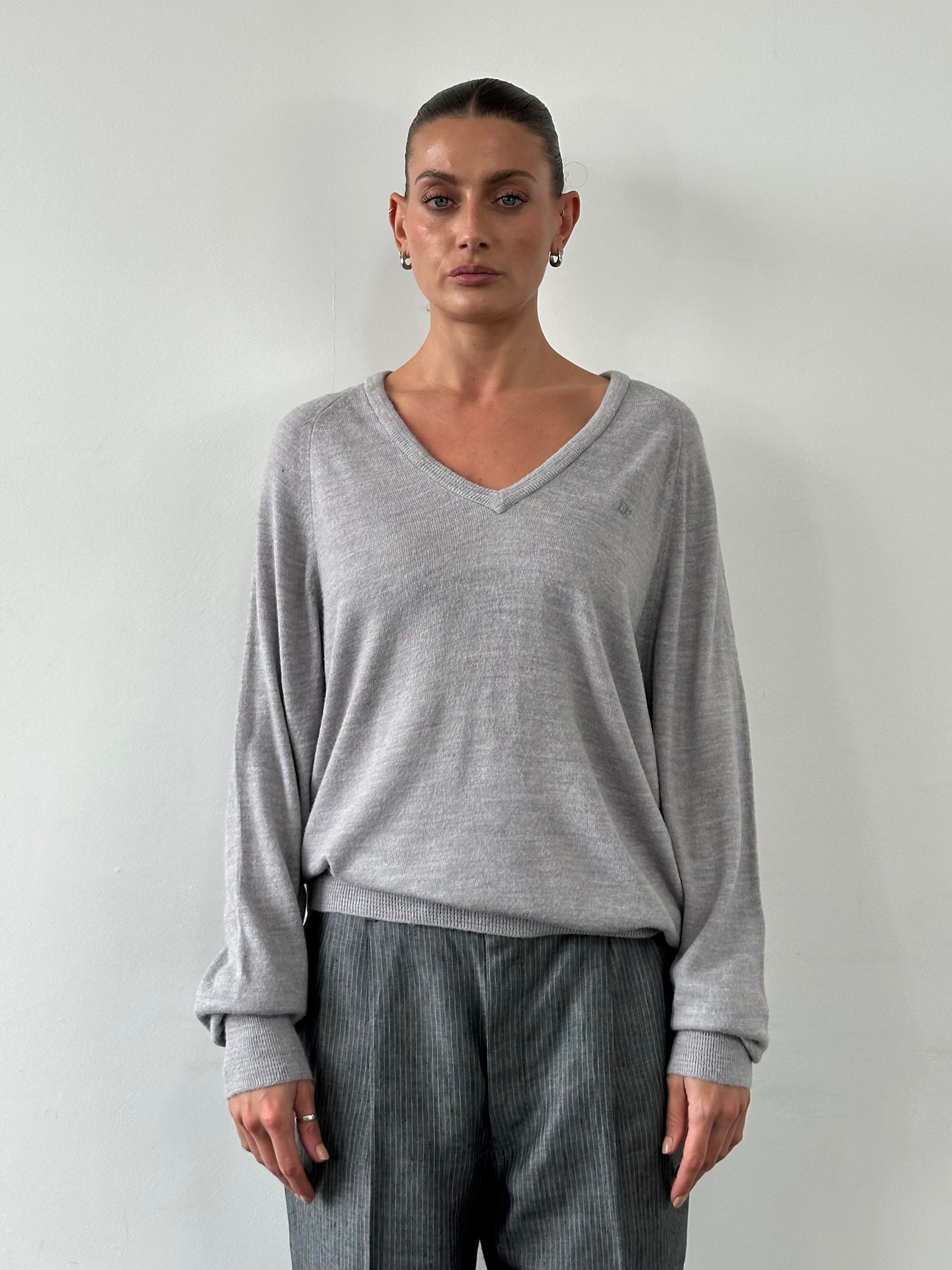 Christian Dior 1980s V-neck logo knitted jumper in size L/XL, featuring a classic Dior logo pattern and soft knit fabric.