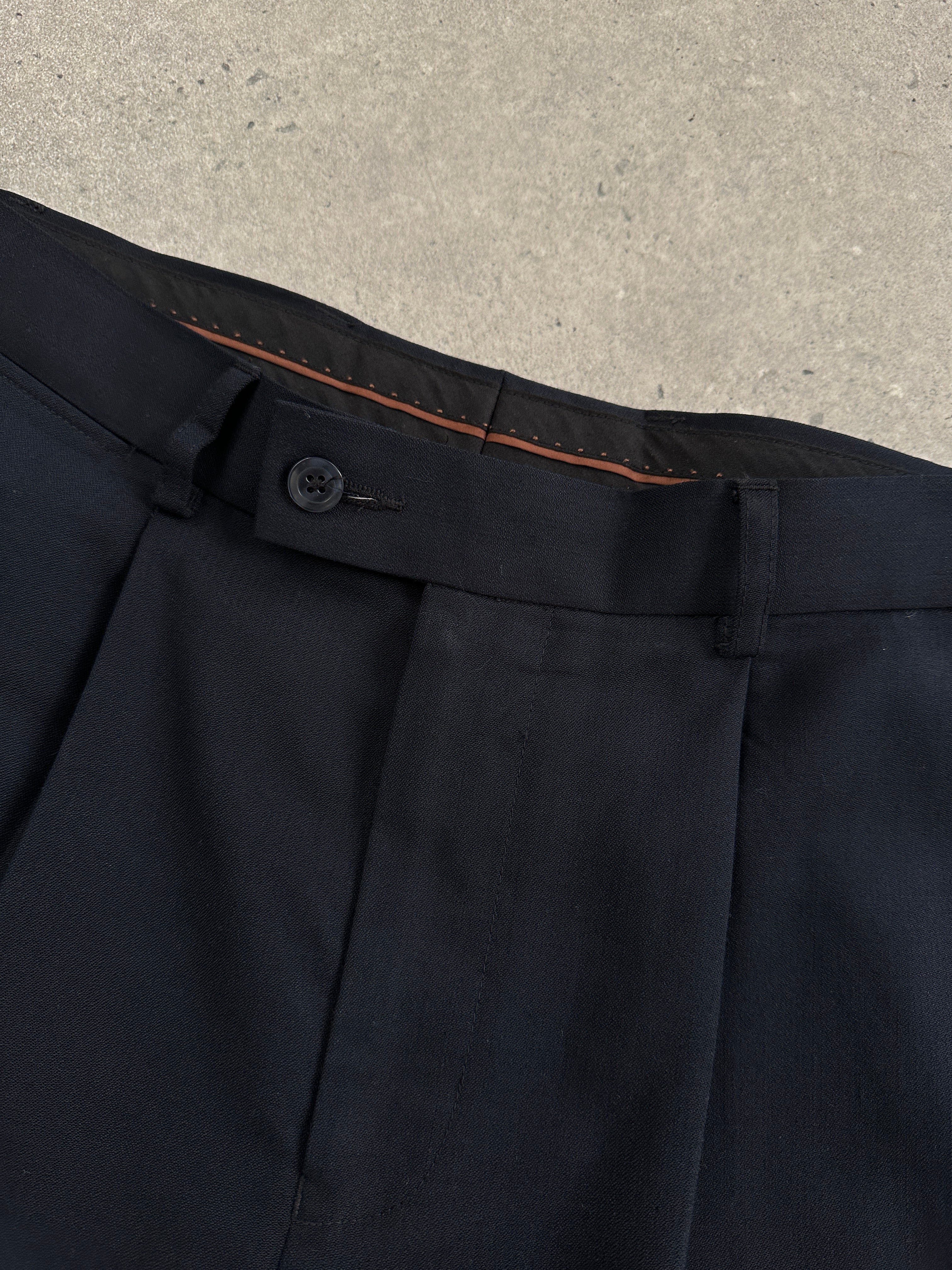 Vintage wool high-waisted straight leg trousers in neutral tones, displayed on a hanger with a plain background.