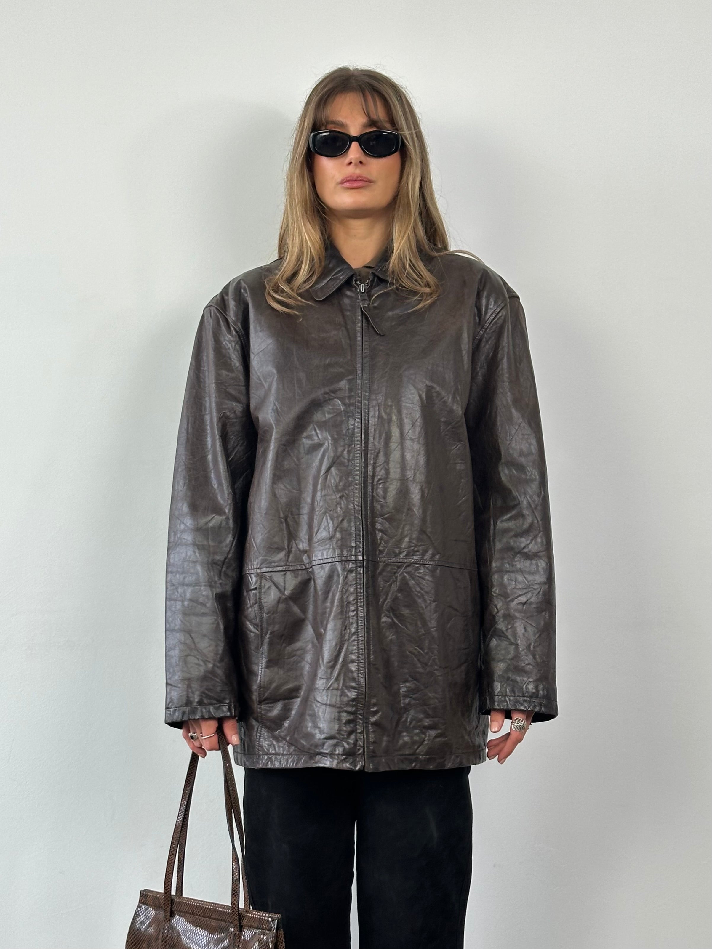 Vintage crinkled leather jacket in XL size, showcasing textured distressed leather and classic style with a front zipper and collar.