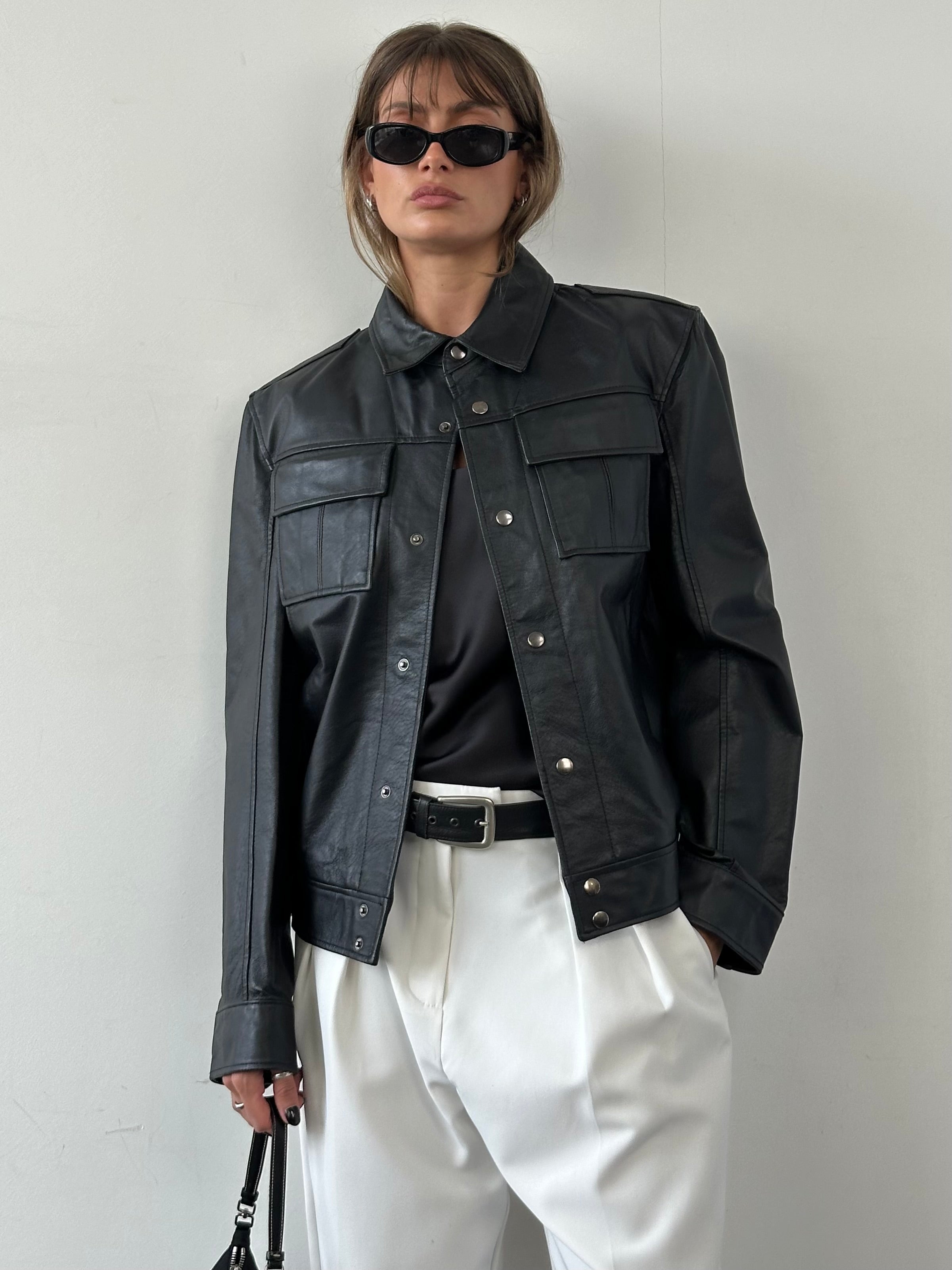 Vintage leather jacket for men, size M, with classic design, featuring a rugged textured look and stylish collar detail.