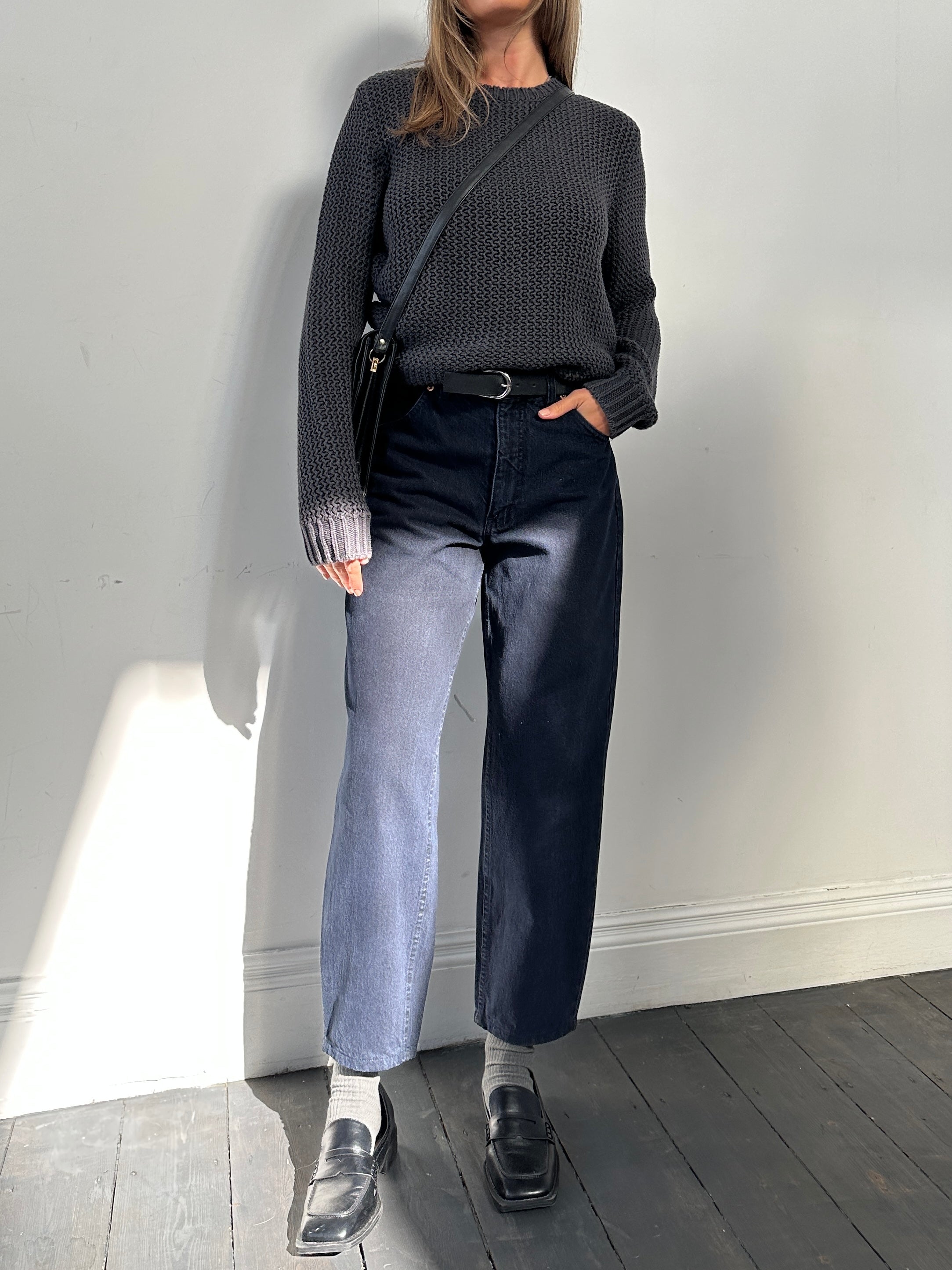 Valentino tapered high-waisted denim jeans in W28, displayed on a hanger with visible stitching and classic five-pocket design.