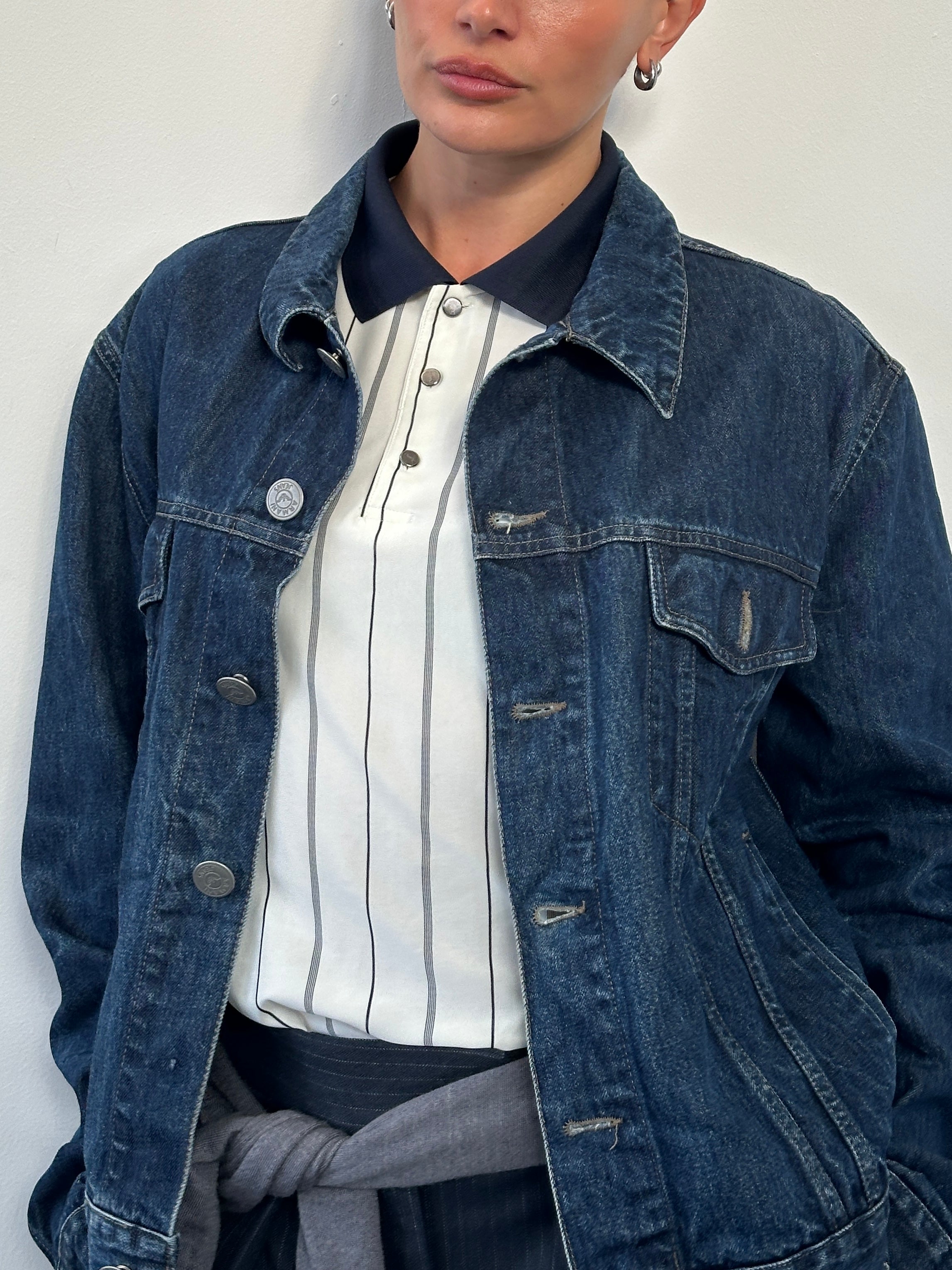 Armani Jeans 1900s mid wash denim jacket displayed on a hanger, stylish casual outerwear for men.