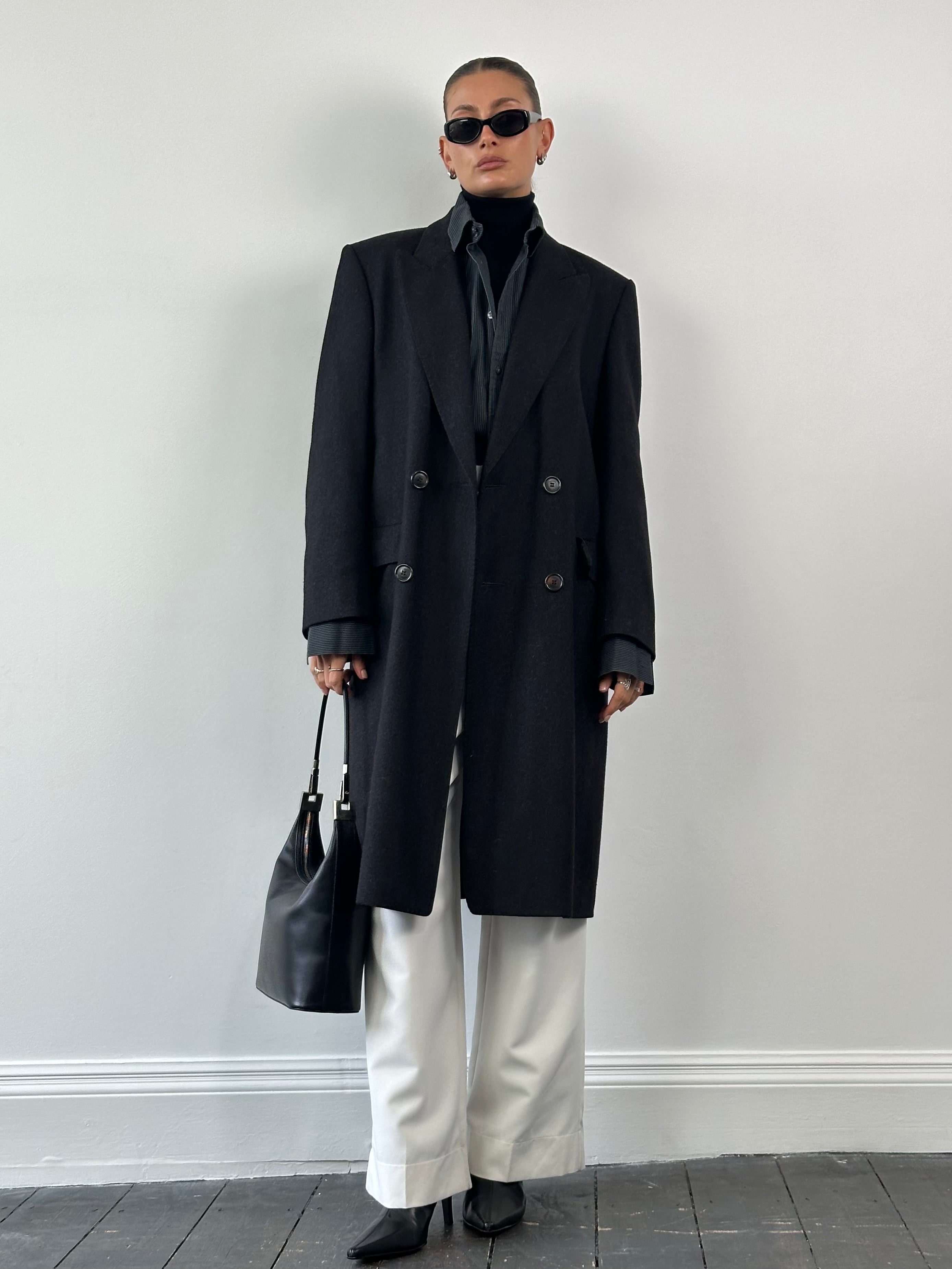 Christian Dior pure wool double-breasted coat in size L/XL, tailored fit with classic lapels and button details, stylish winter outerwear.