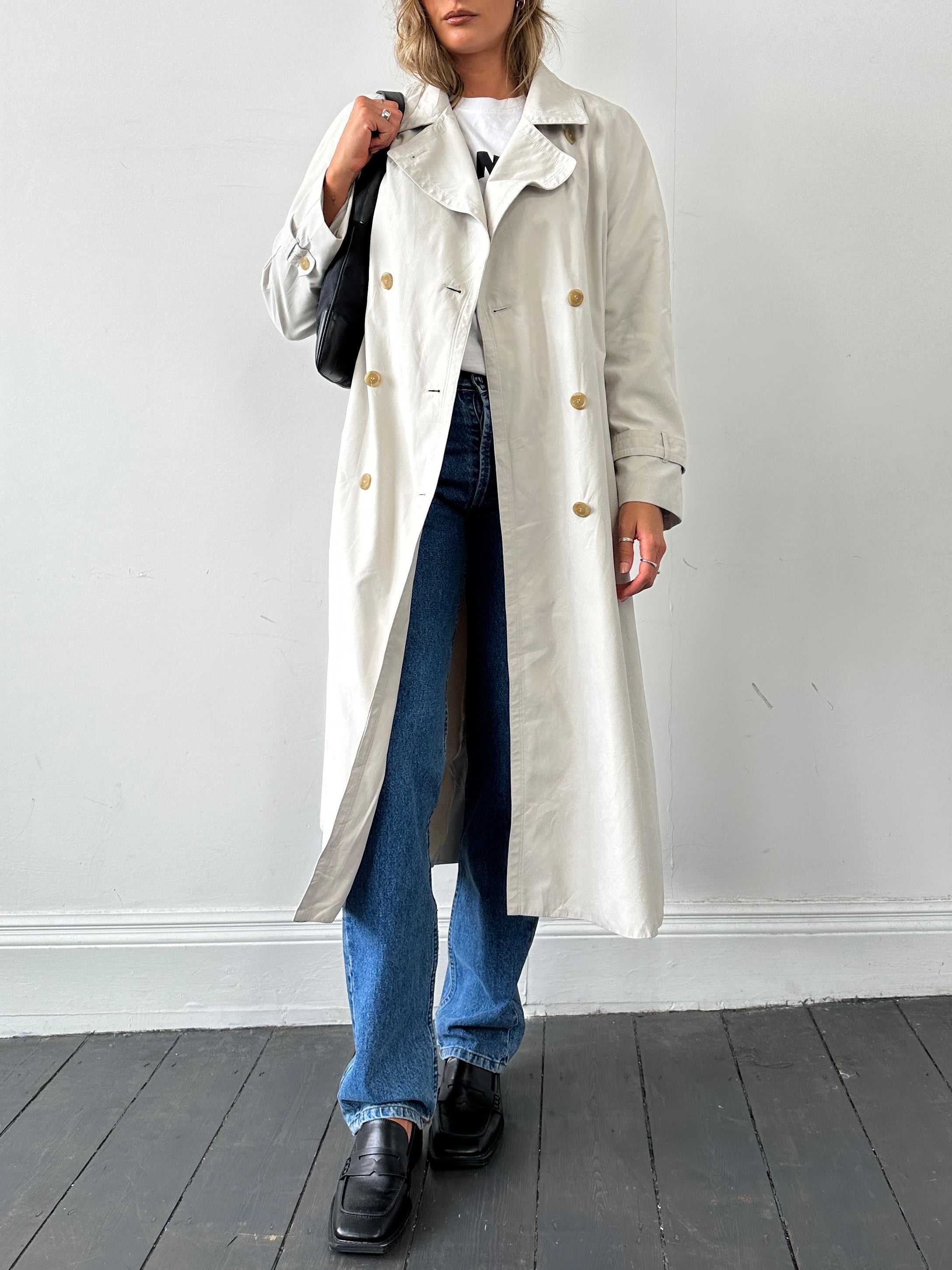 Vintage brand vintage floor-length trench coat in size L, showcasing classic design with belt and double-breasted front.