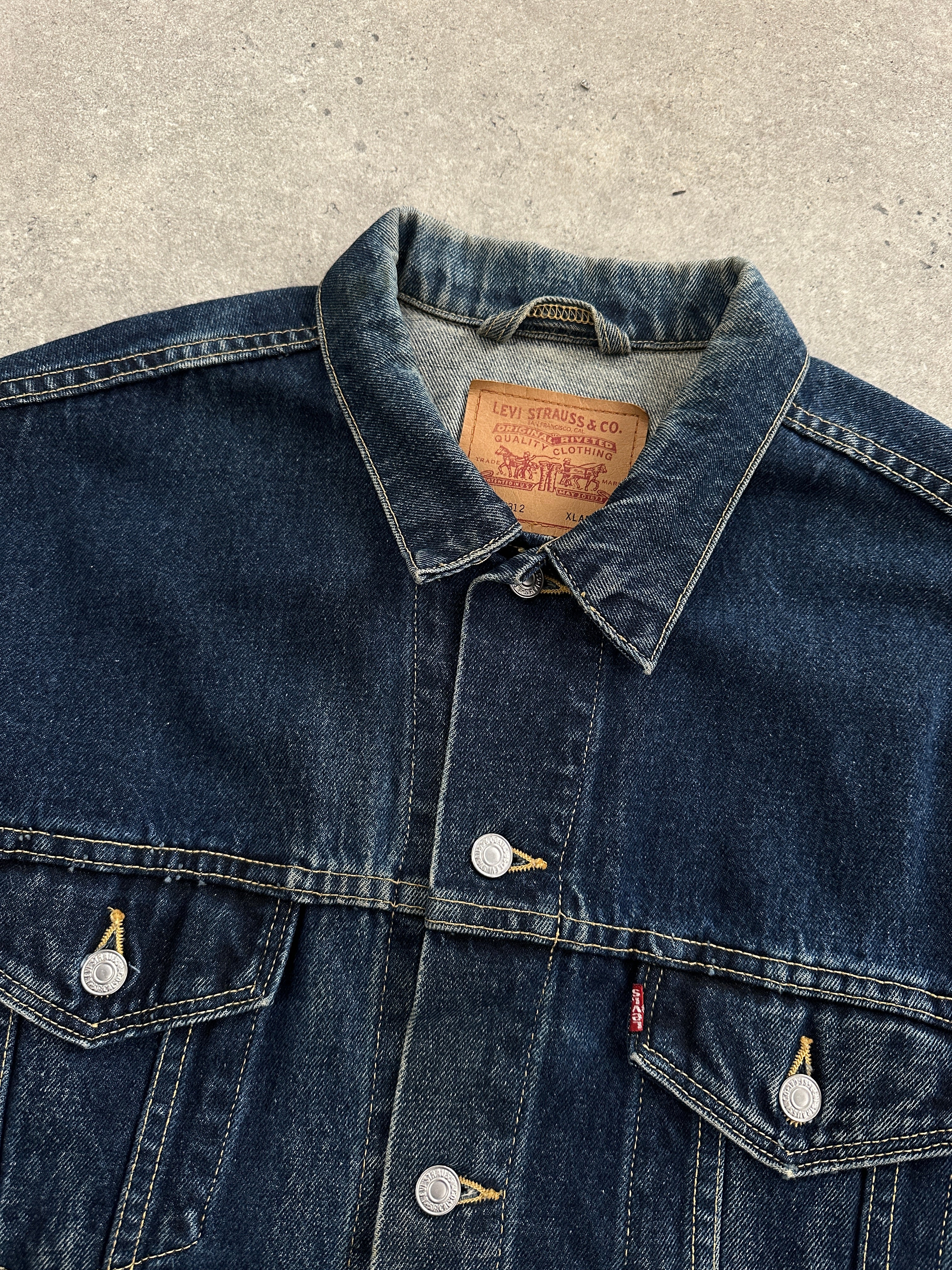 Levi’s denim jacket in XXL size, classic blue denim with button front and collar, casual style, shown on a hanger.