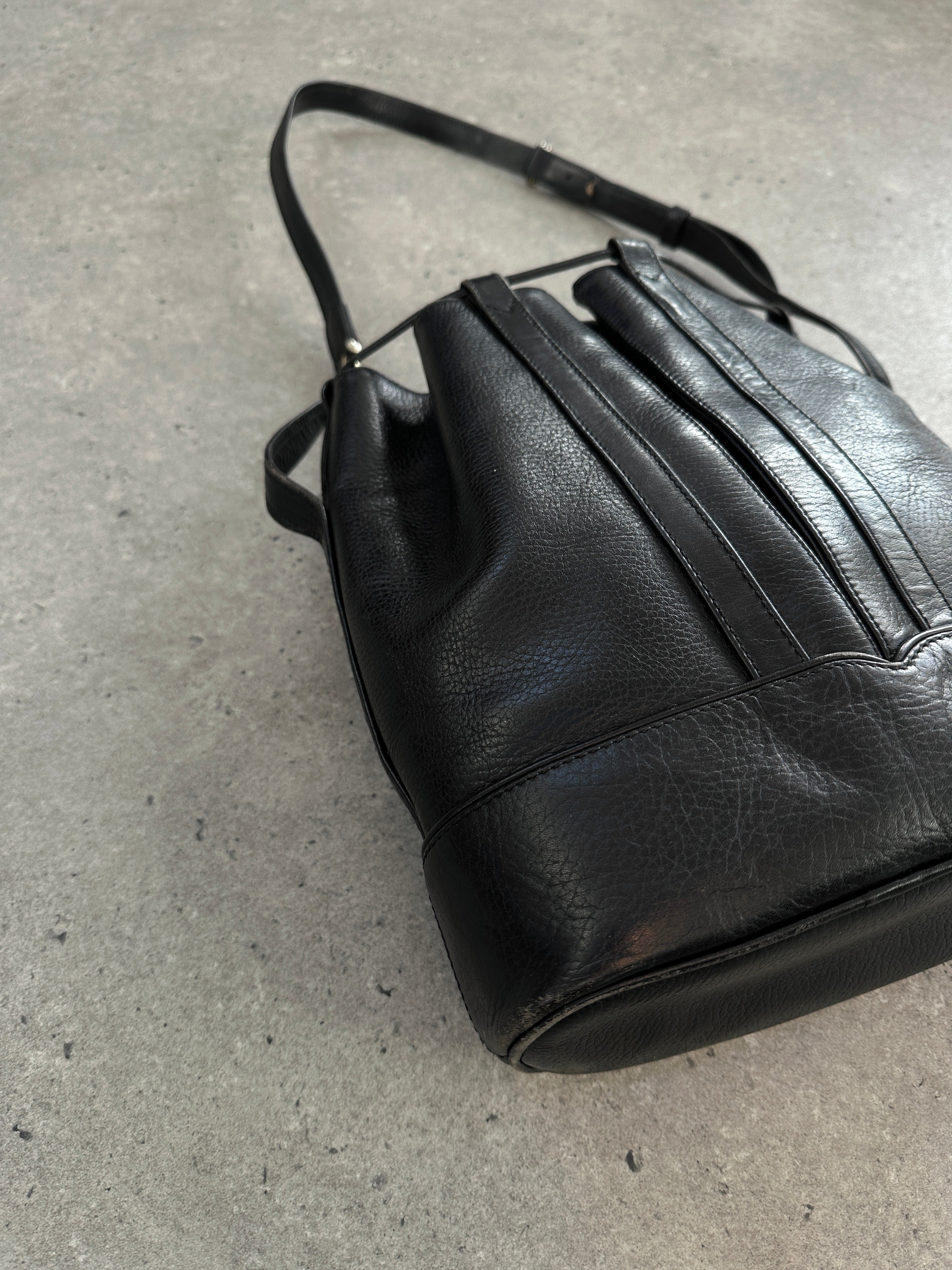 Cartier 1980s leather bucket bag with structured shape and classic design, featuring a smooth leather finish and subtle branding.