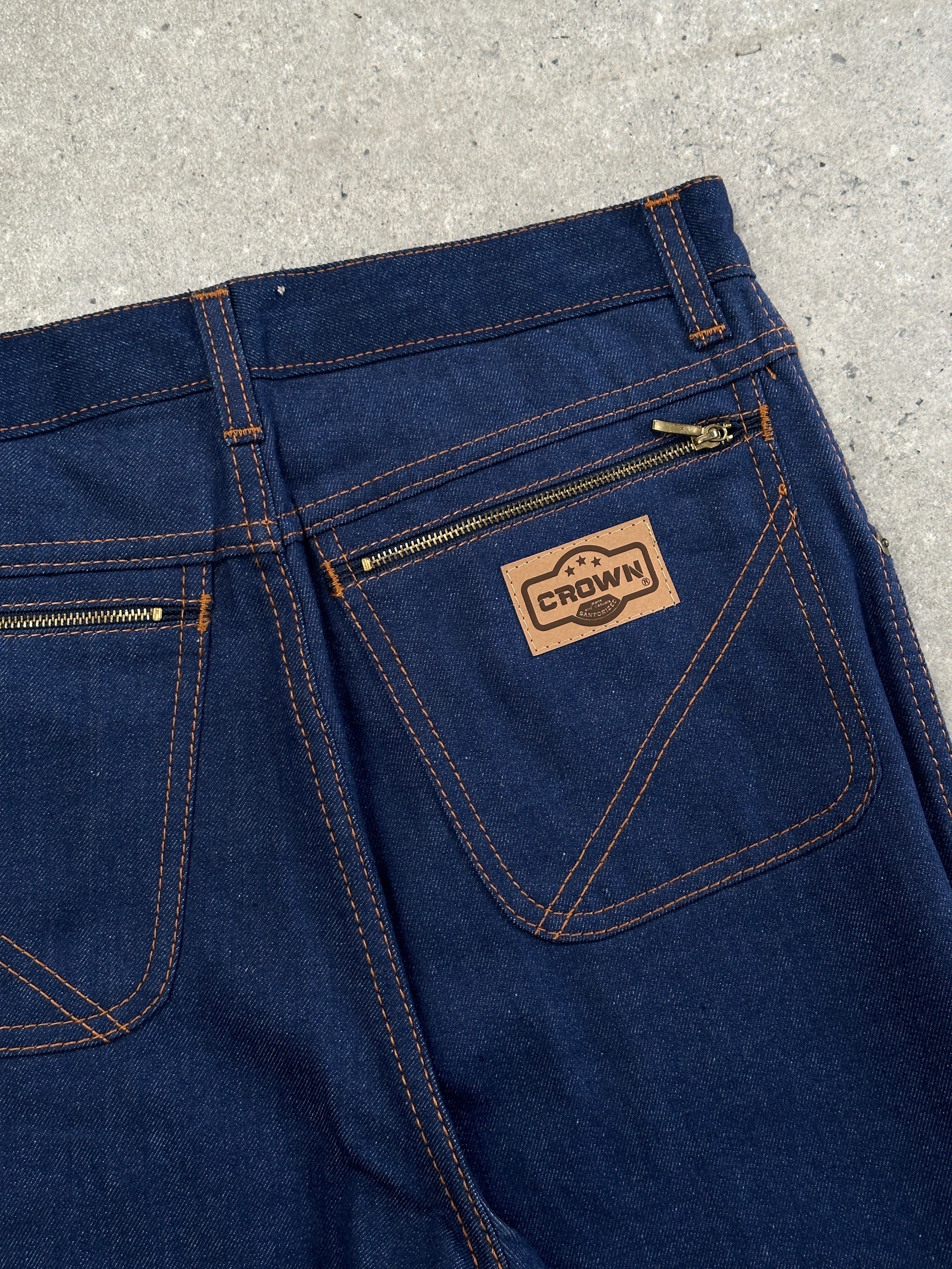 Vintage Italian 1990s high-waisted straight leg denim jeans in W28, featuring classic blue denim and vintage stitching details.