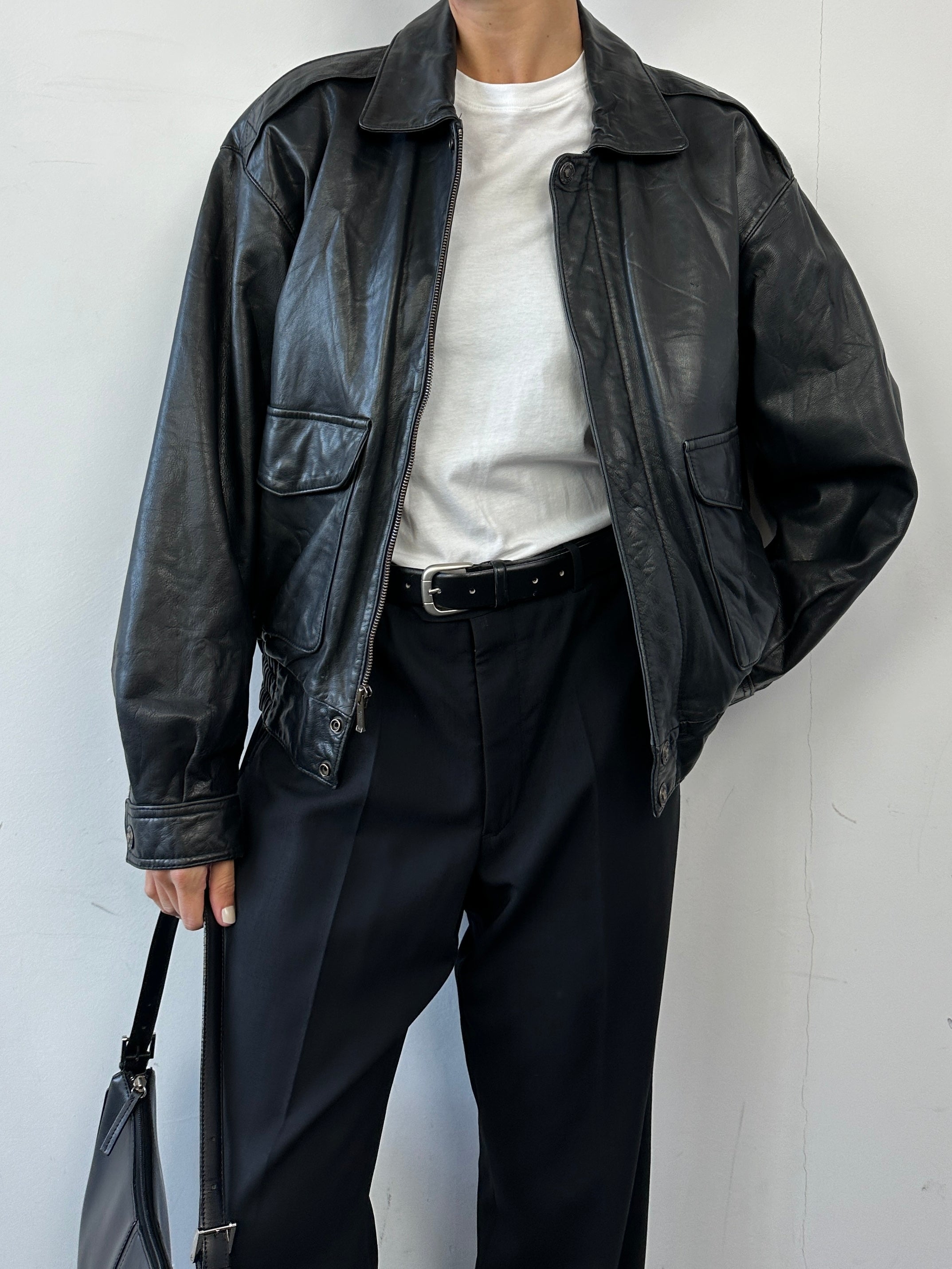 Vintage leather bomber jacket in size S/M, featuring classic design, smooth leather texture, and ribbed cuffs and collar.
