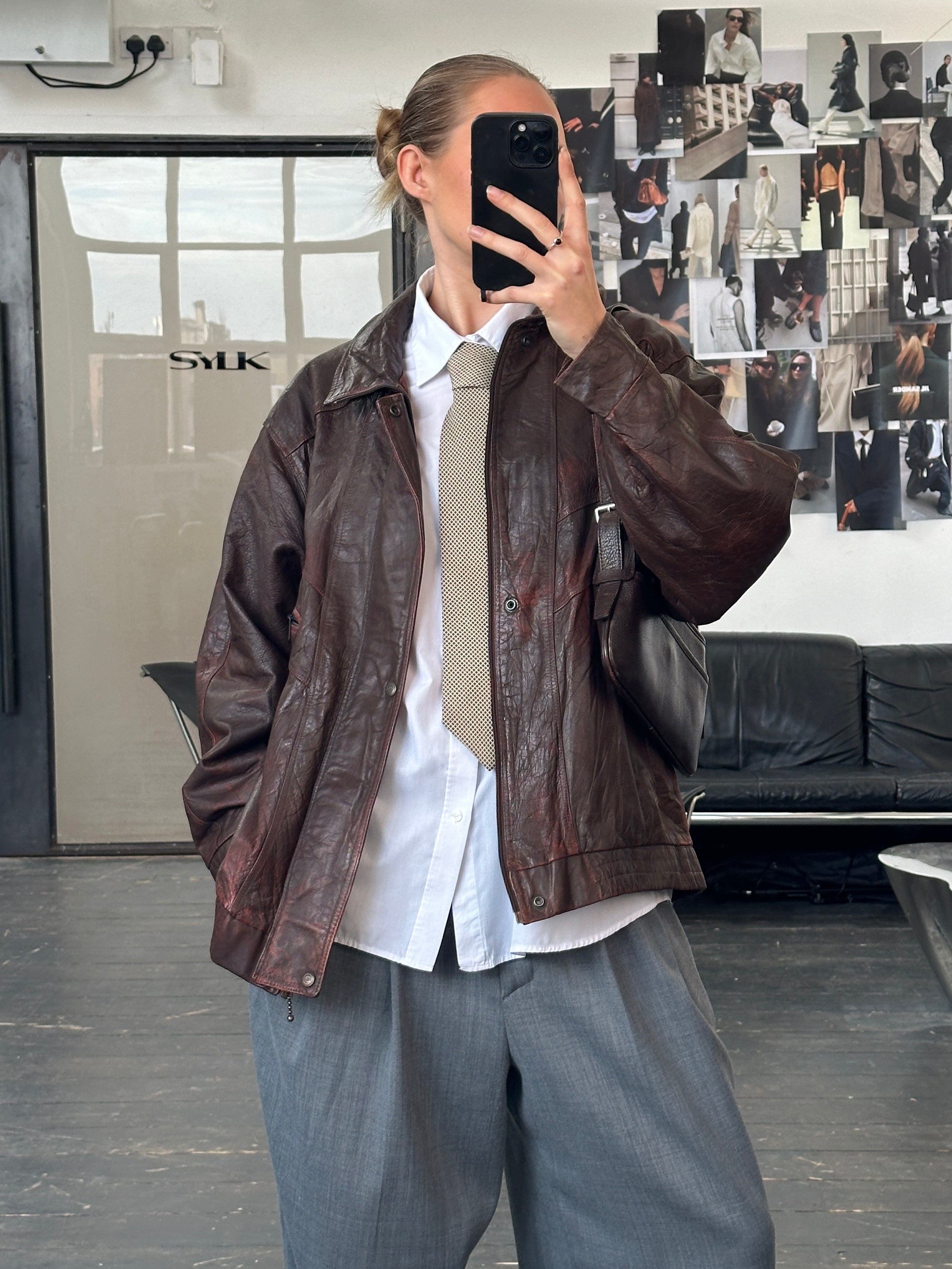 Vintage 1990s aged leather bomber jacket with funnel neck in XL size, featuring classic design and distressed leather finish.