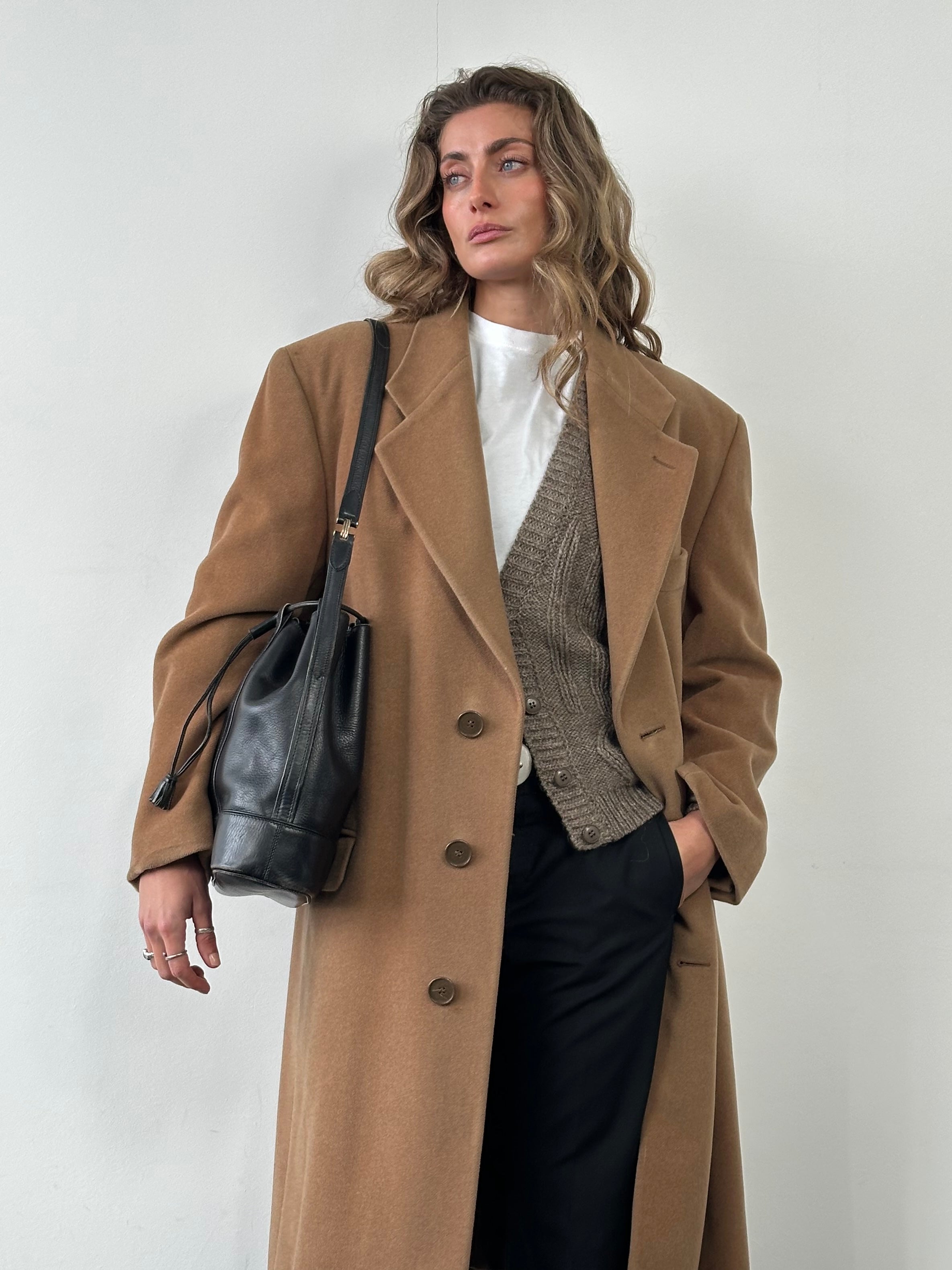 Cartier leather bucket bag from the 1980s featuring a rounded silhouette, leather strap, and classic design details.