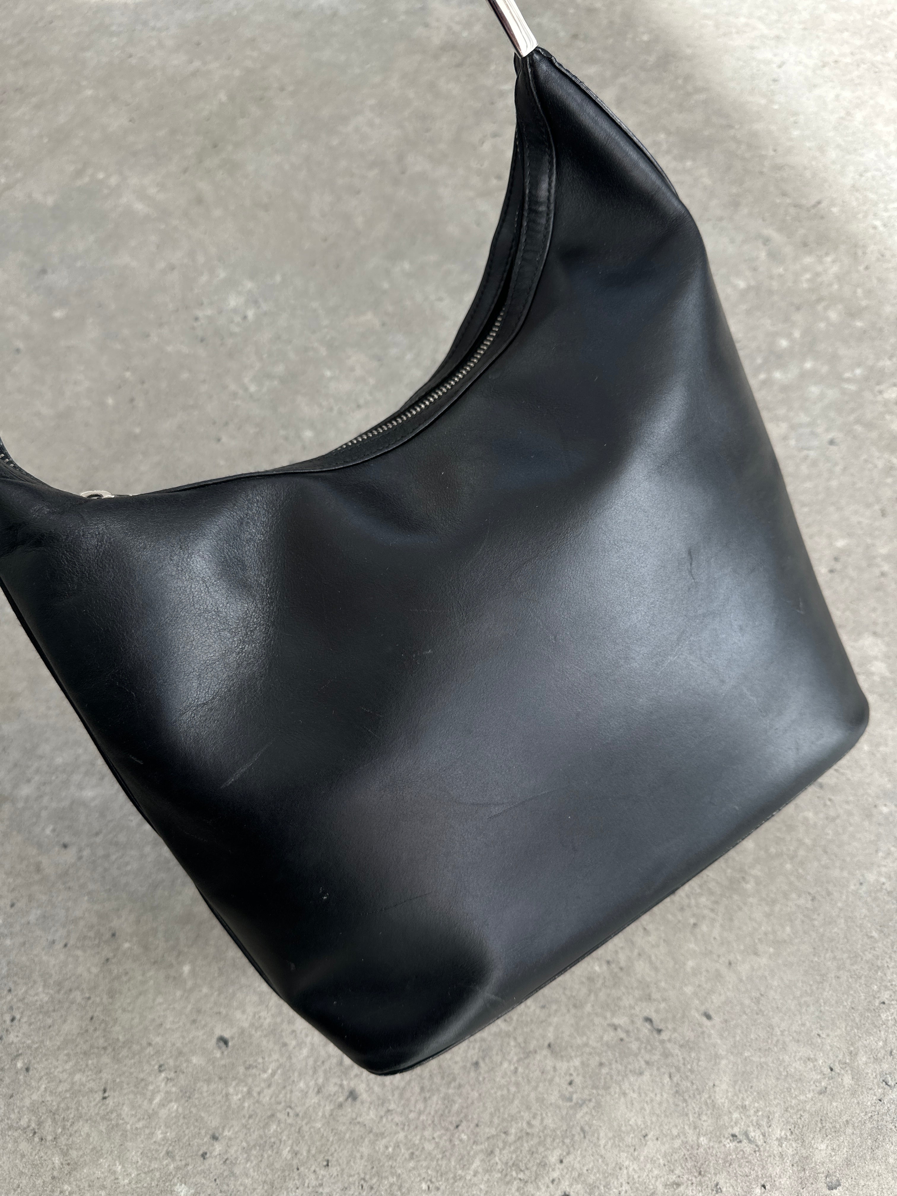 Gucci 1990s Tom Ford GG leather hobo shoulder bag with dark brown exterior and subtle brand logo, stylish and vintage design.