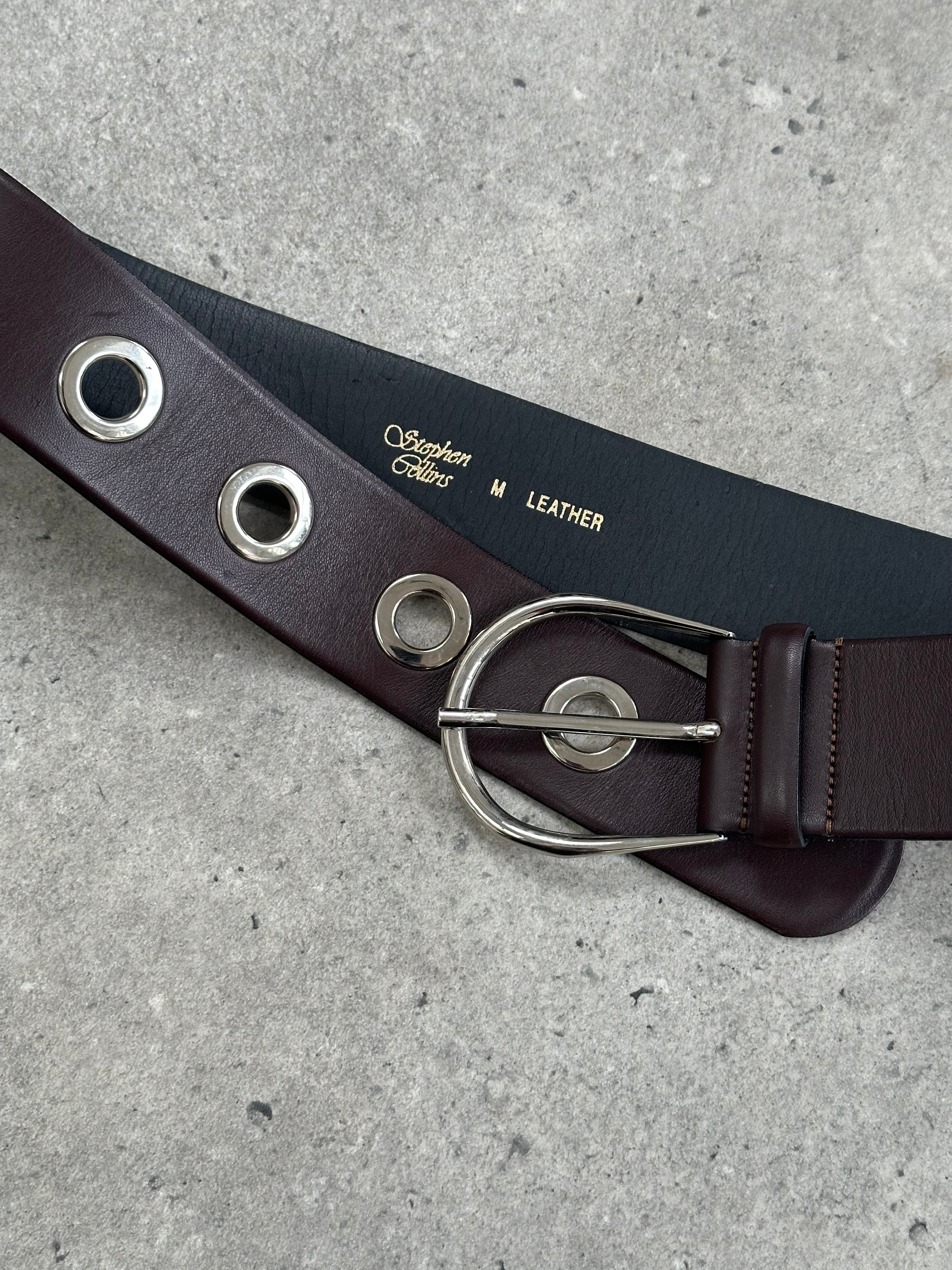 Vintage 1990s eyelet leather belt with adjustable W28-34, featuring metal eyelets and classic style.