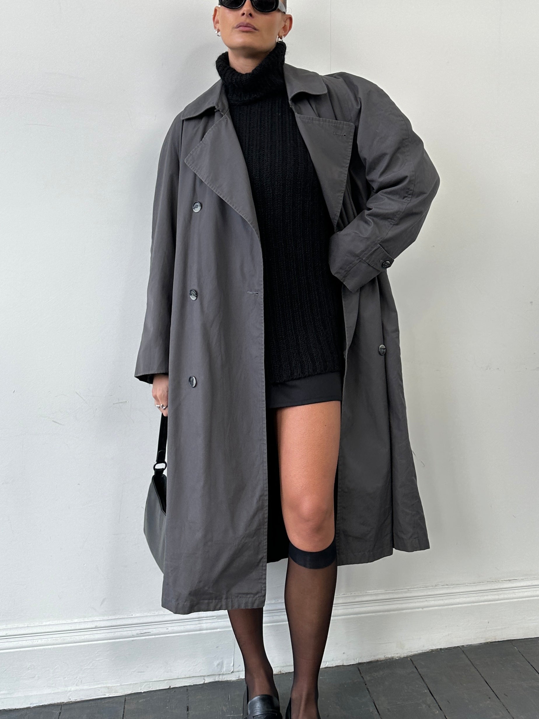 Christian Dior double-breasted trench coat in size L, stylish beige coat with classic collar and button details.