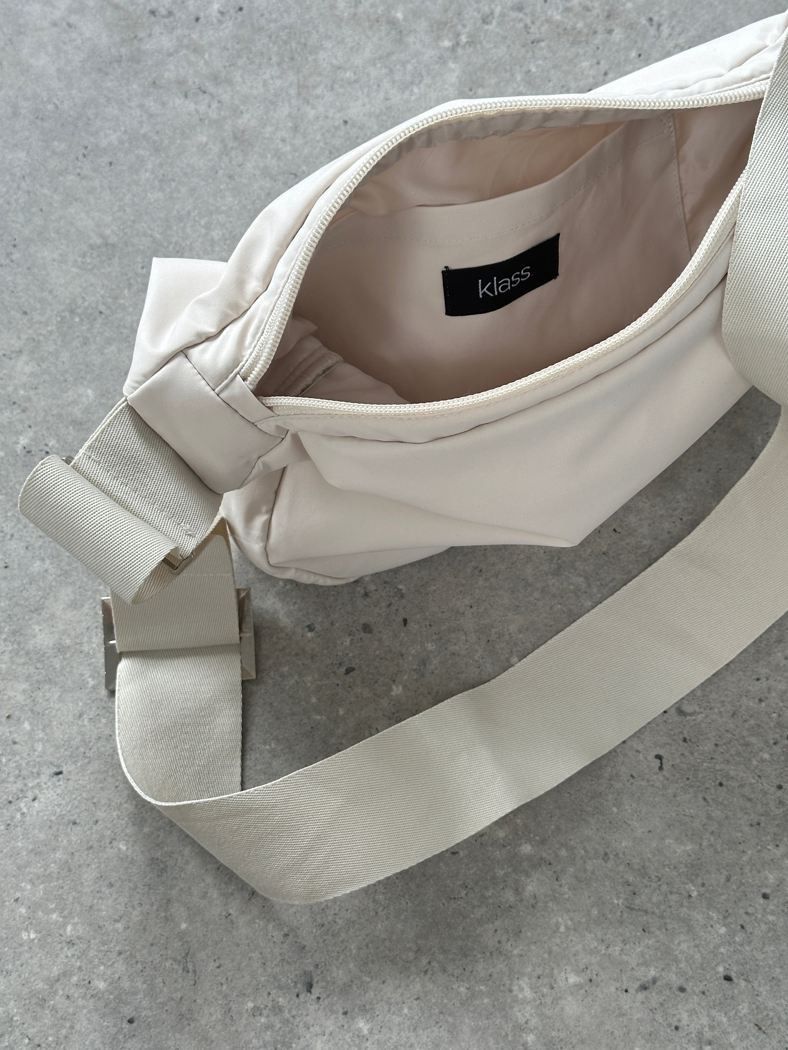 Vintage waterproof round crossbody bag with a classic design, featuring a durable exterior and adjustable strap.