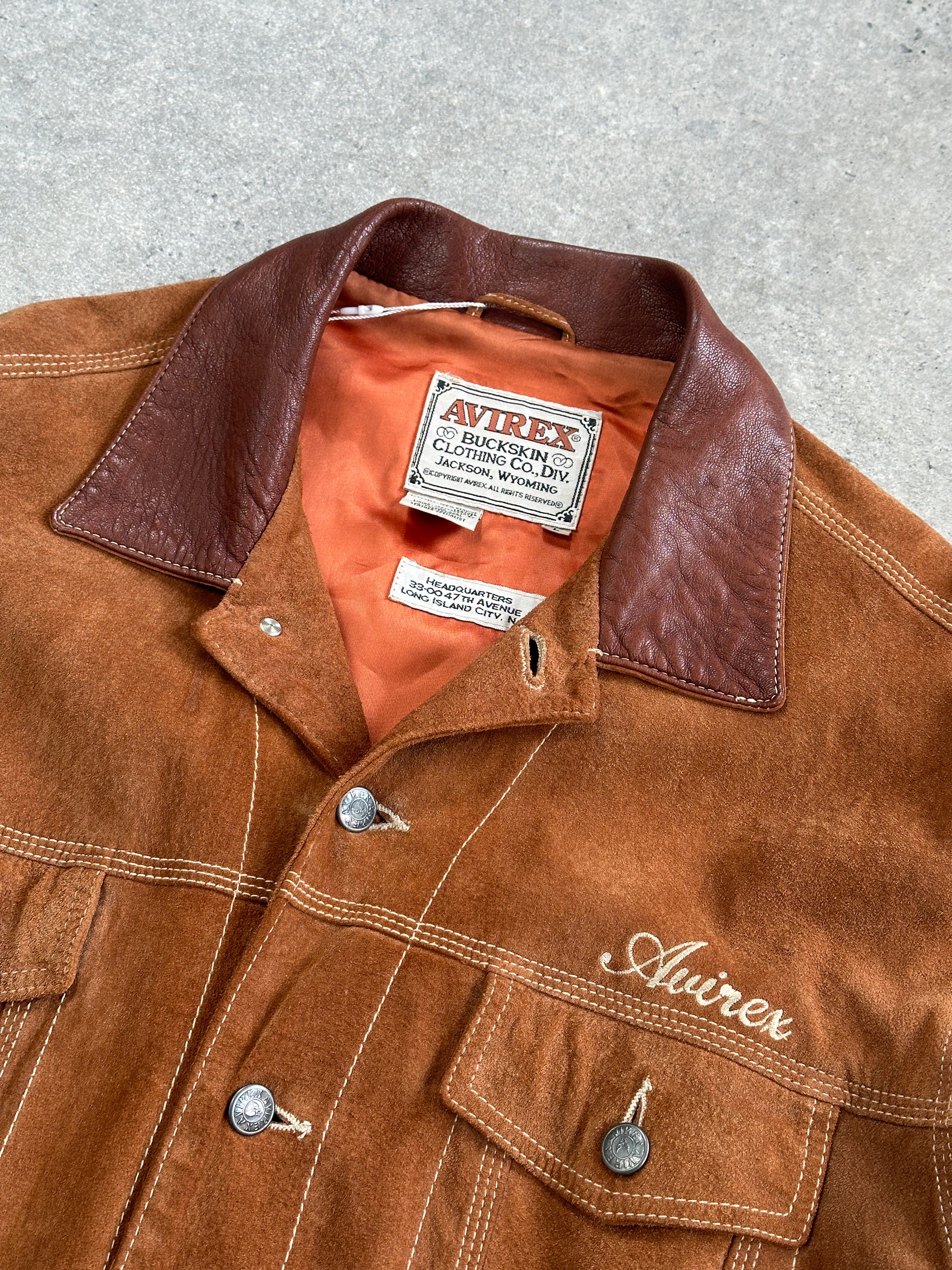 Avirex suede trucker jacket in size large, featuring a classic design with a soft suede exterior and traditional trucker style.
