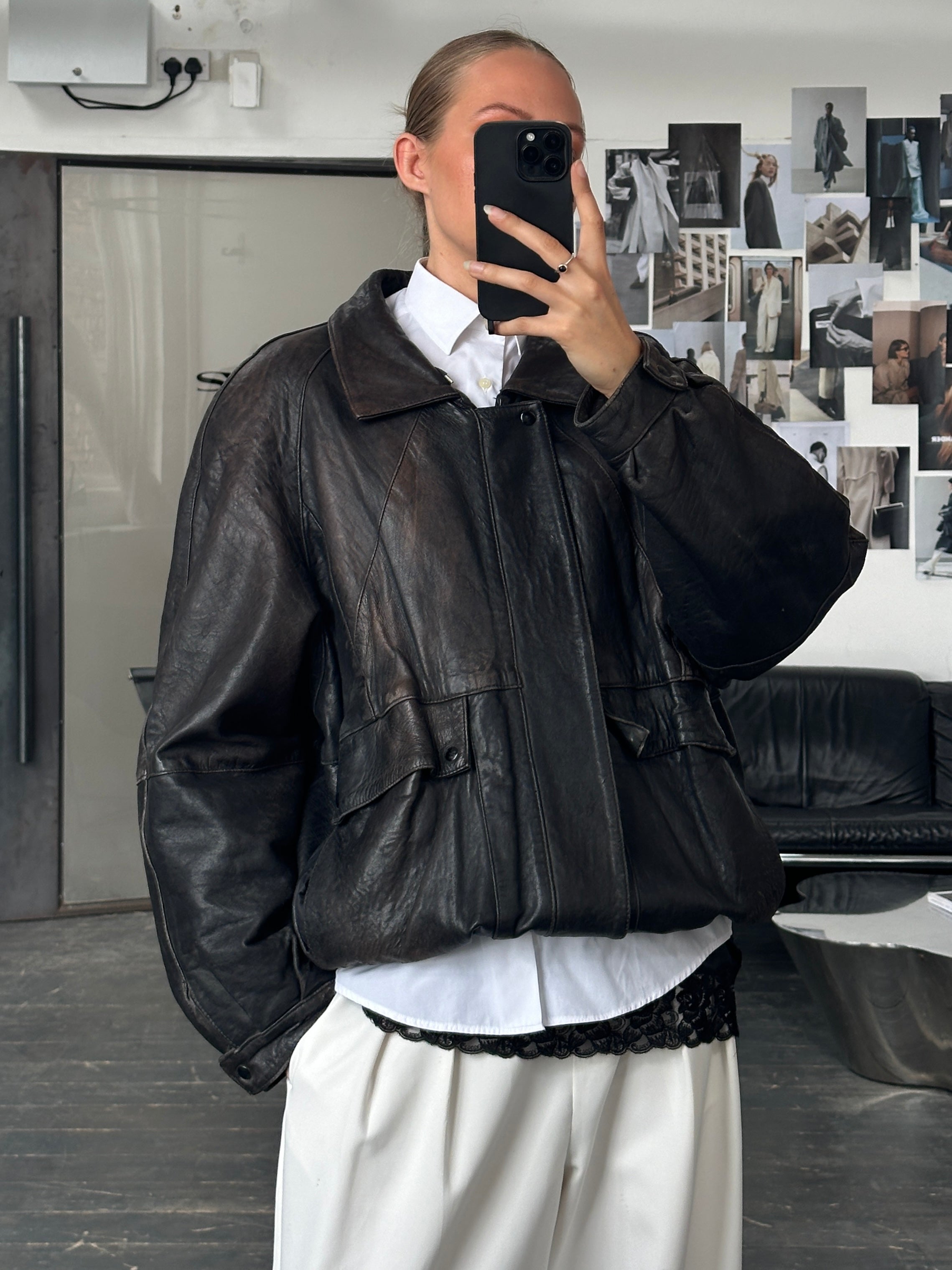 Vintage brand vintage 1980s aged leather bomber jacket in XL size, showcasing distressed leather and classic bomber style.