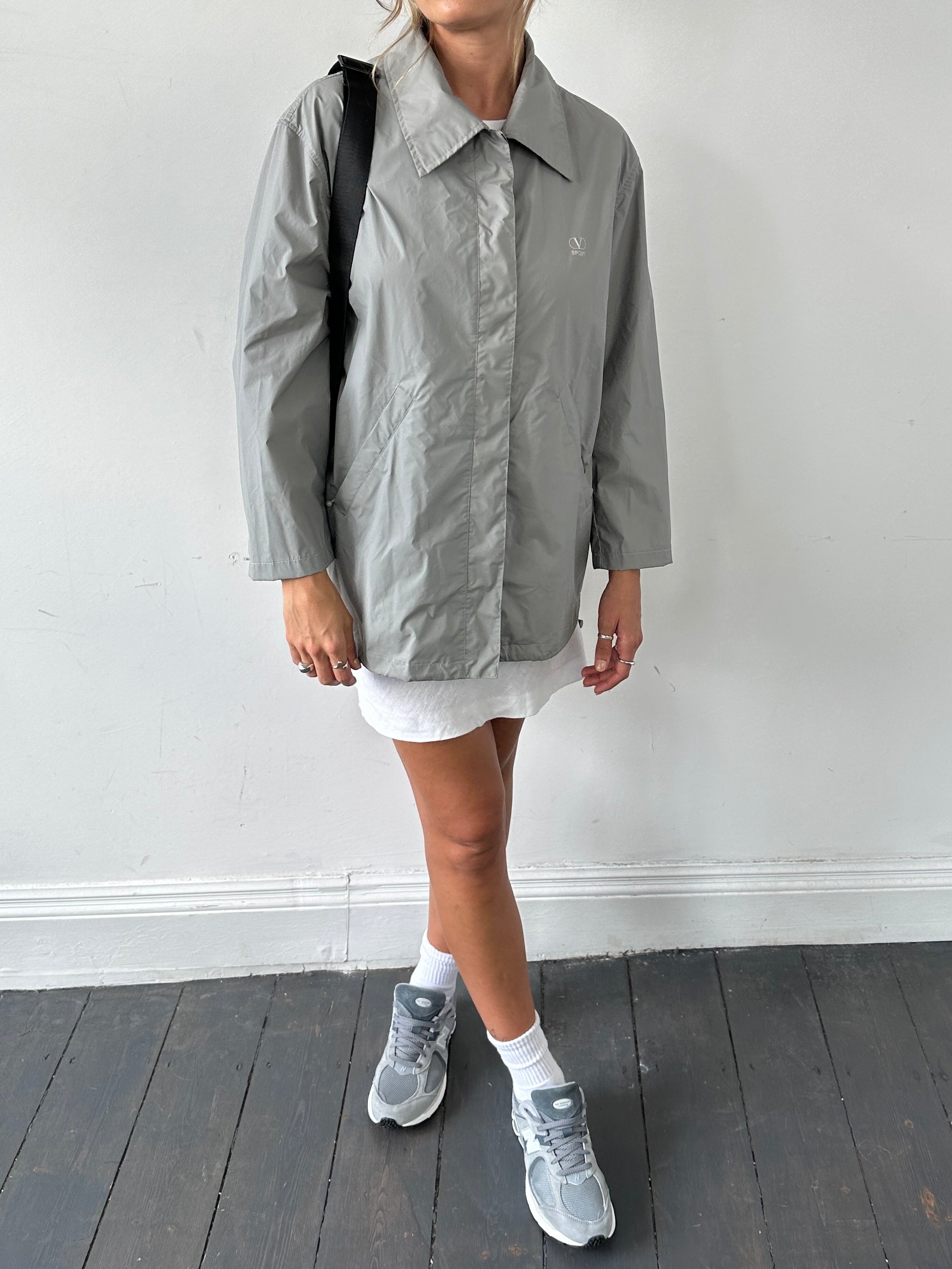 Valentino sport raincoat jacket in size L, featuring a sleek design and waterproof material, displayed on a hanger.