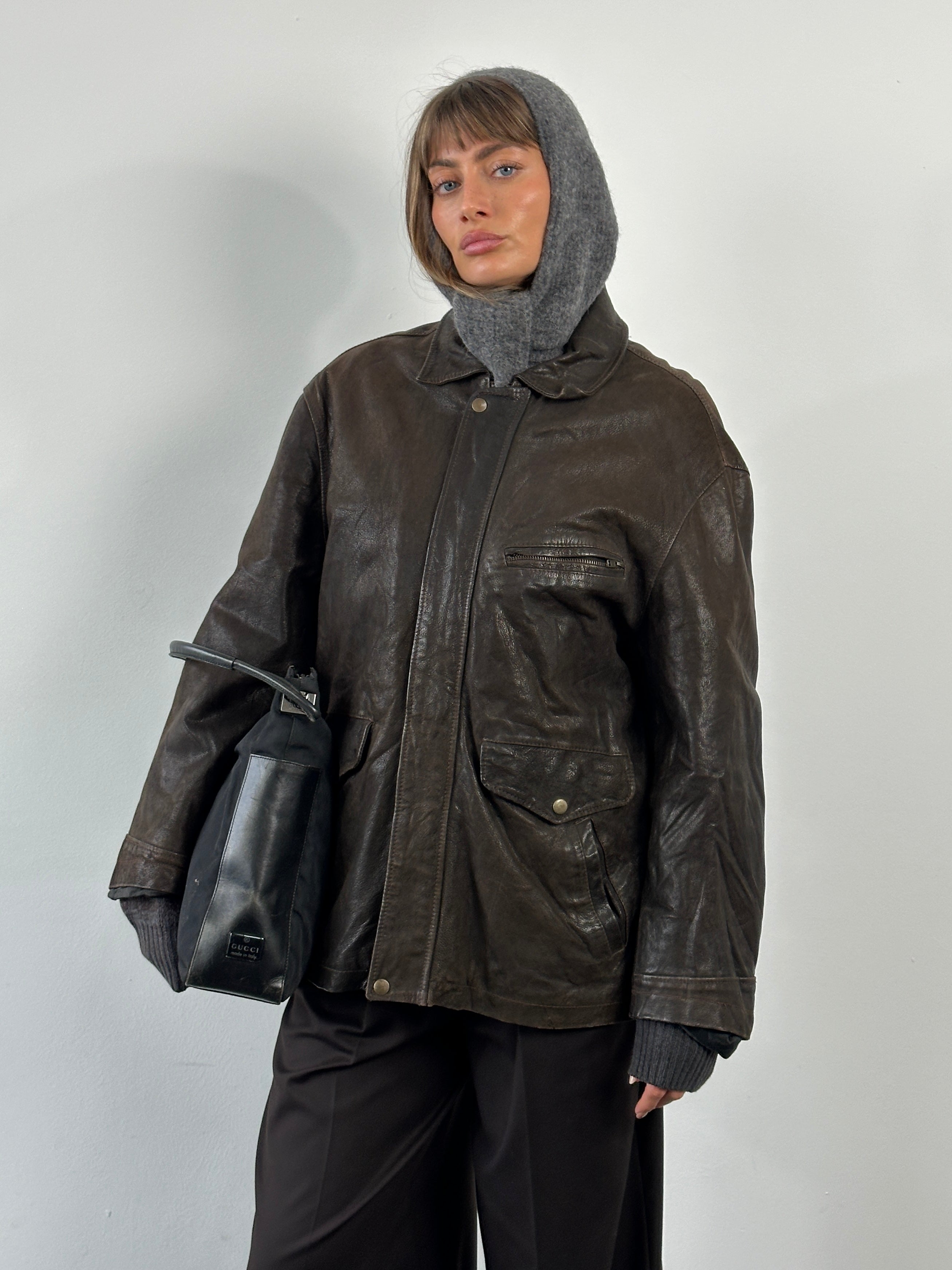 Vintage 1980s leather jacket with concealed placket, in size L/XL, featuring classic vintage style and high-quality leather.