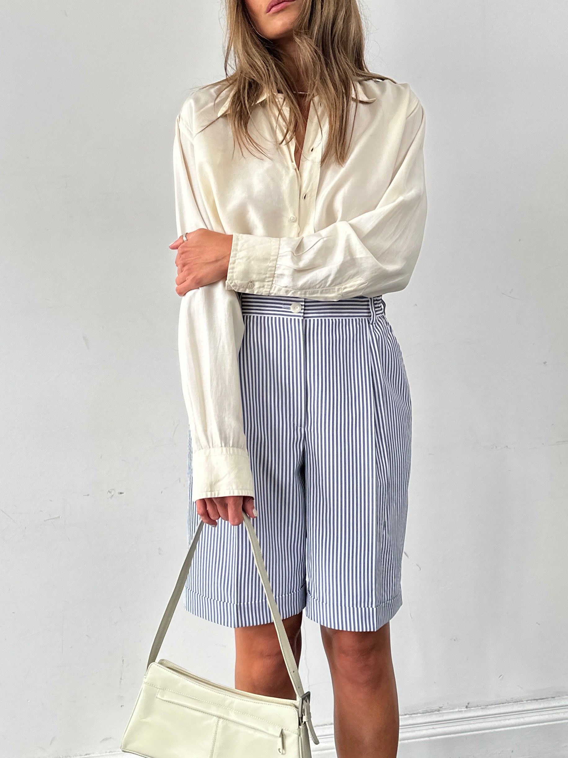 Vintage brand vintage stripe pleated shorts in W28 with a high waist and relaxed fit, featuring colorful vertical stripes.