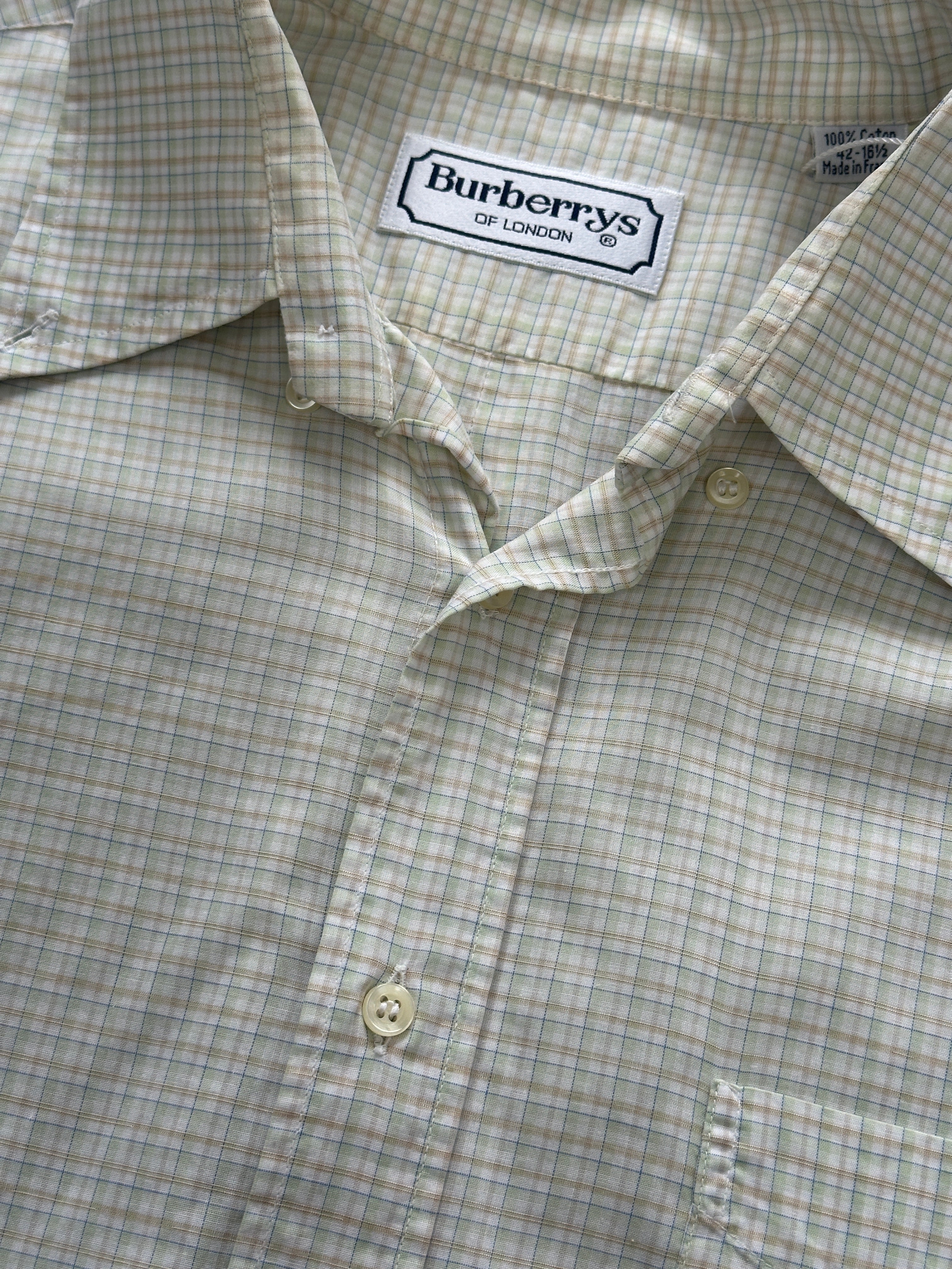 Burberry pure cotton check shirt in size XL, featuring classic plaid pattern and button-down front, displayed on a hanger.
