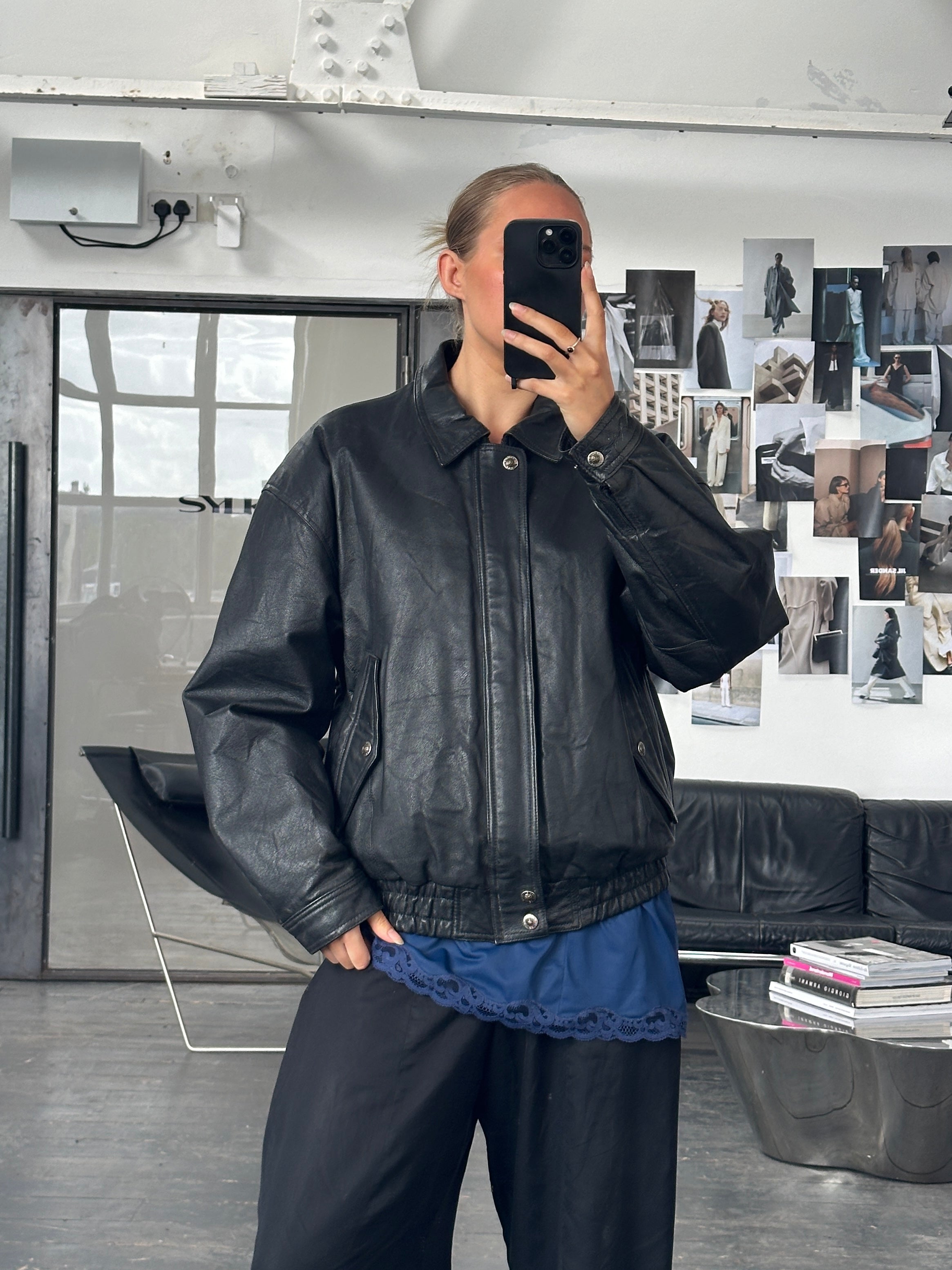 Vintage 1990s leather bomber jacket, classic blouson style with a worn brown finish, front zipper, and ribbed cuffs.