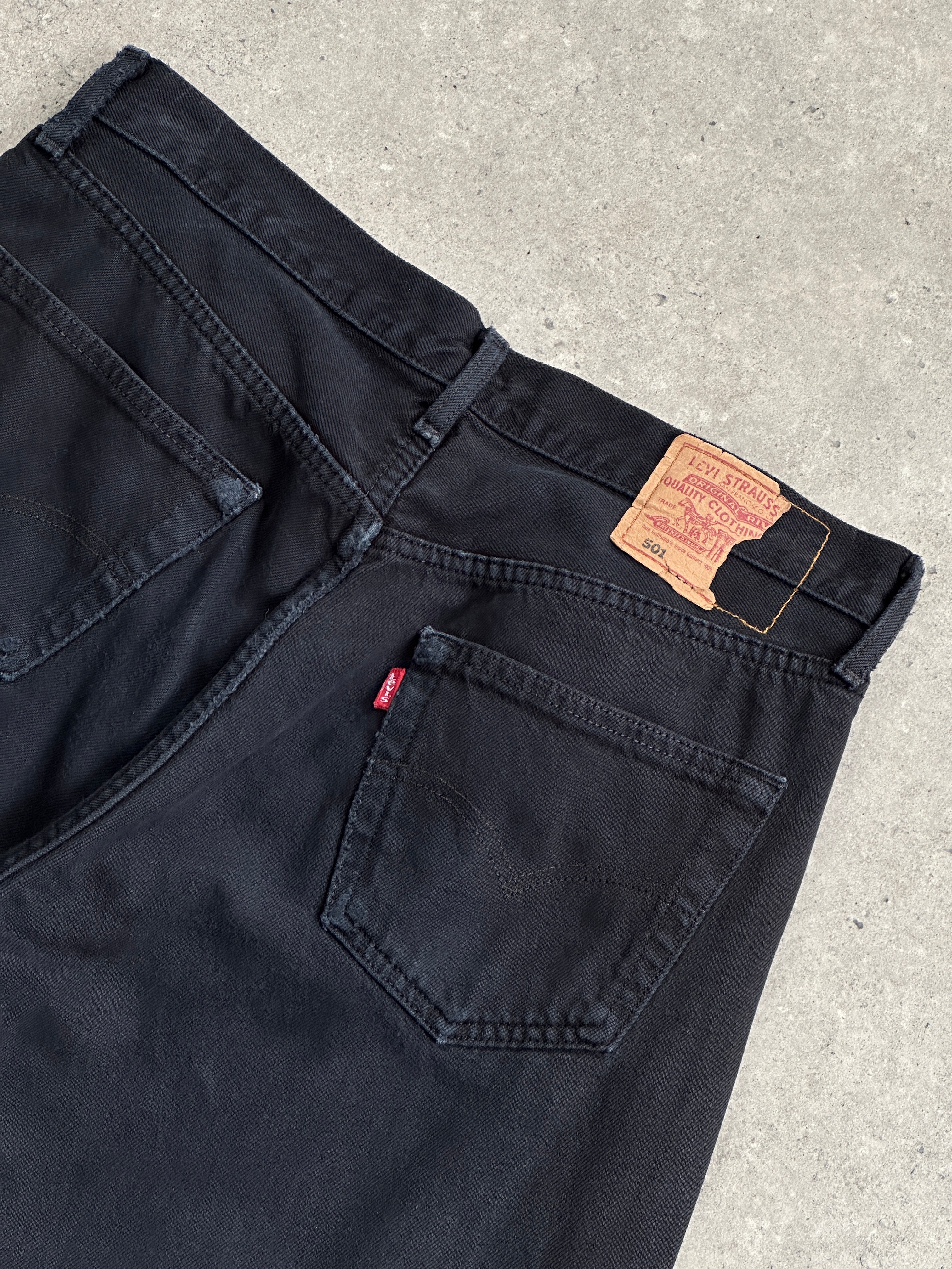 Levi's 501 straight leg high-waisted denim jeans in W32, showing classic blue wash, front pockets, and belt loops.