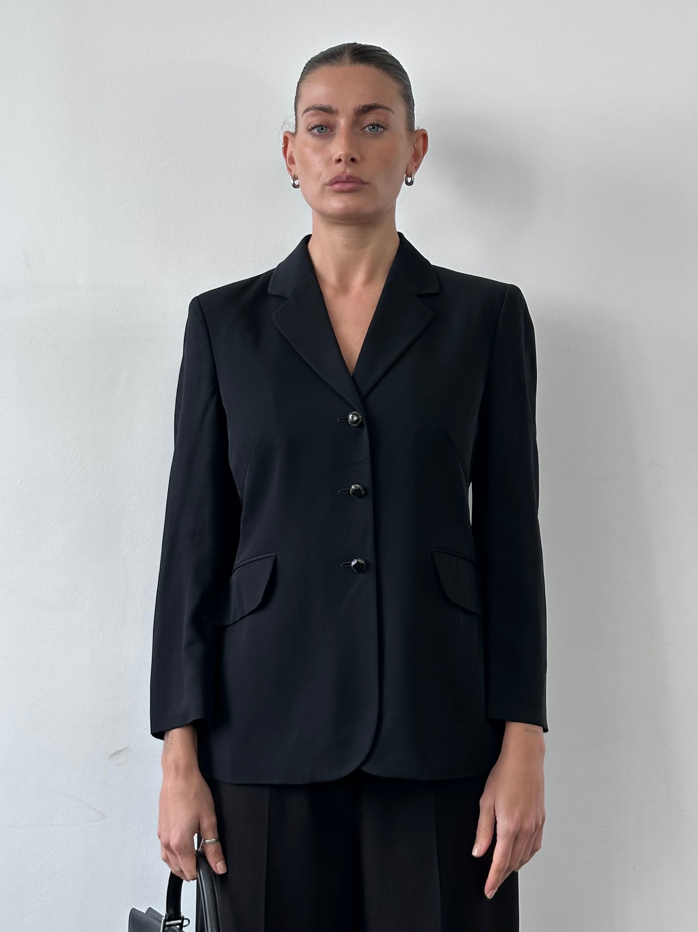 Moschino Cheap & Chic 90s single-breasted blazer in black with tailored fit, lapel collar, and button closure, displayed flat.