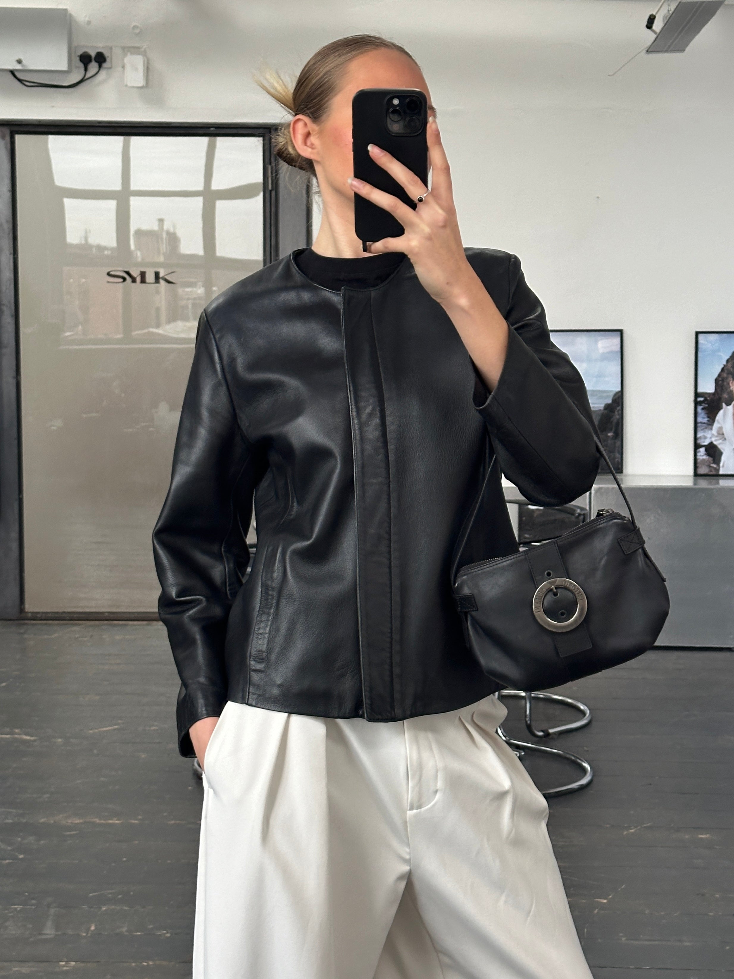 Vintage 1990s round neck leather jacket in minimal style, size M, featuring smooth black leather and classic design.