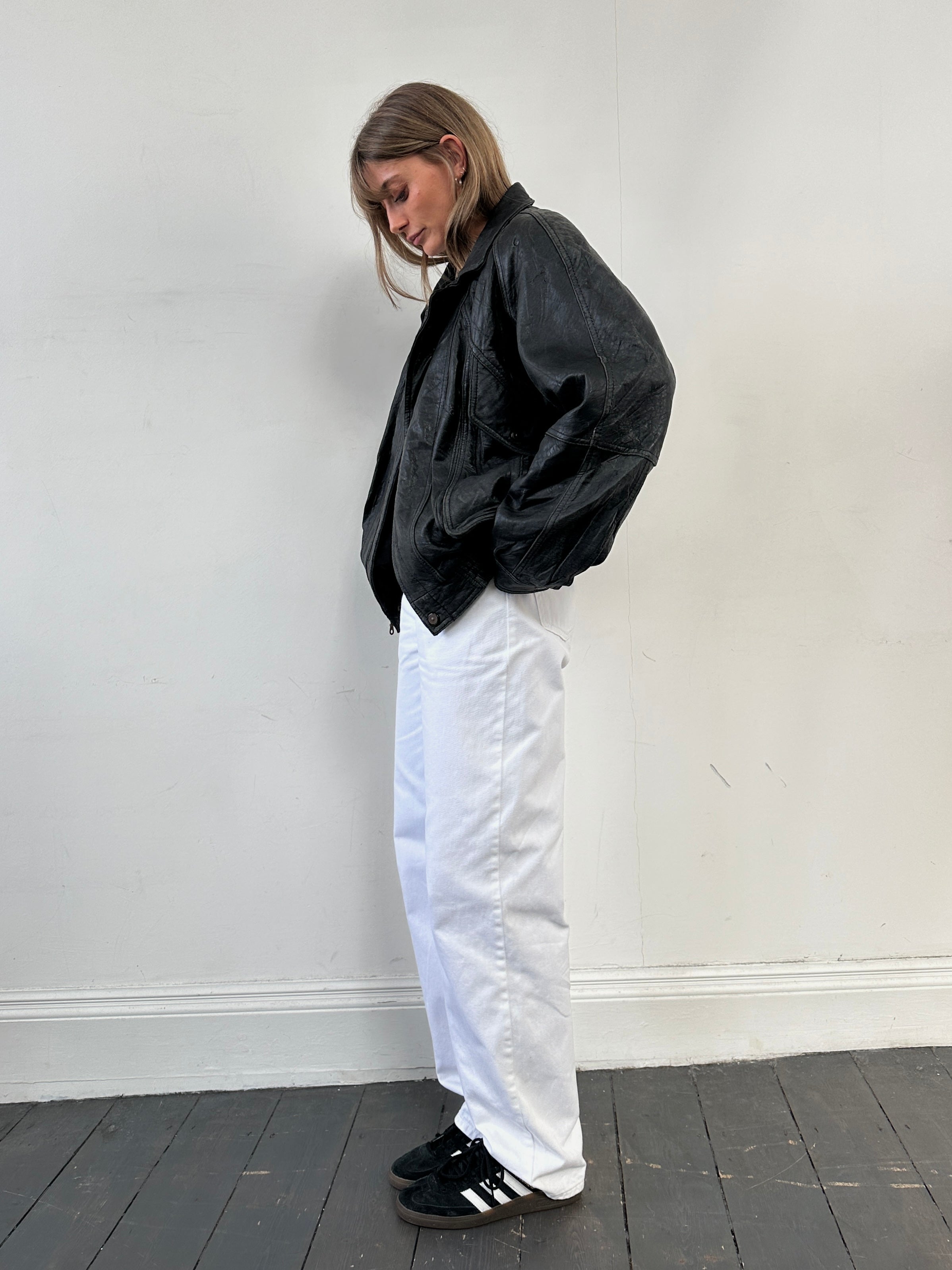 Vintage distressed leather bomber jacket, size large, featuring rugged texture and classic design.