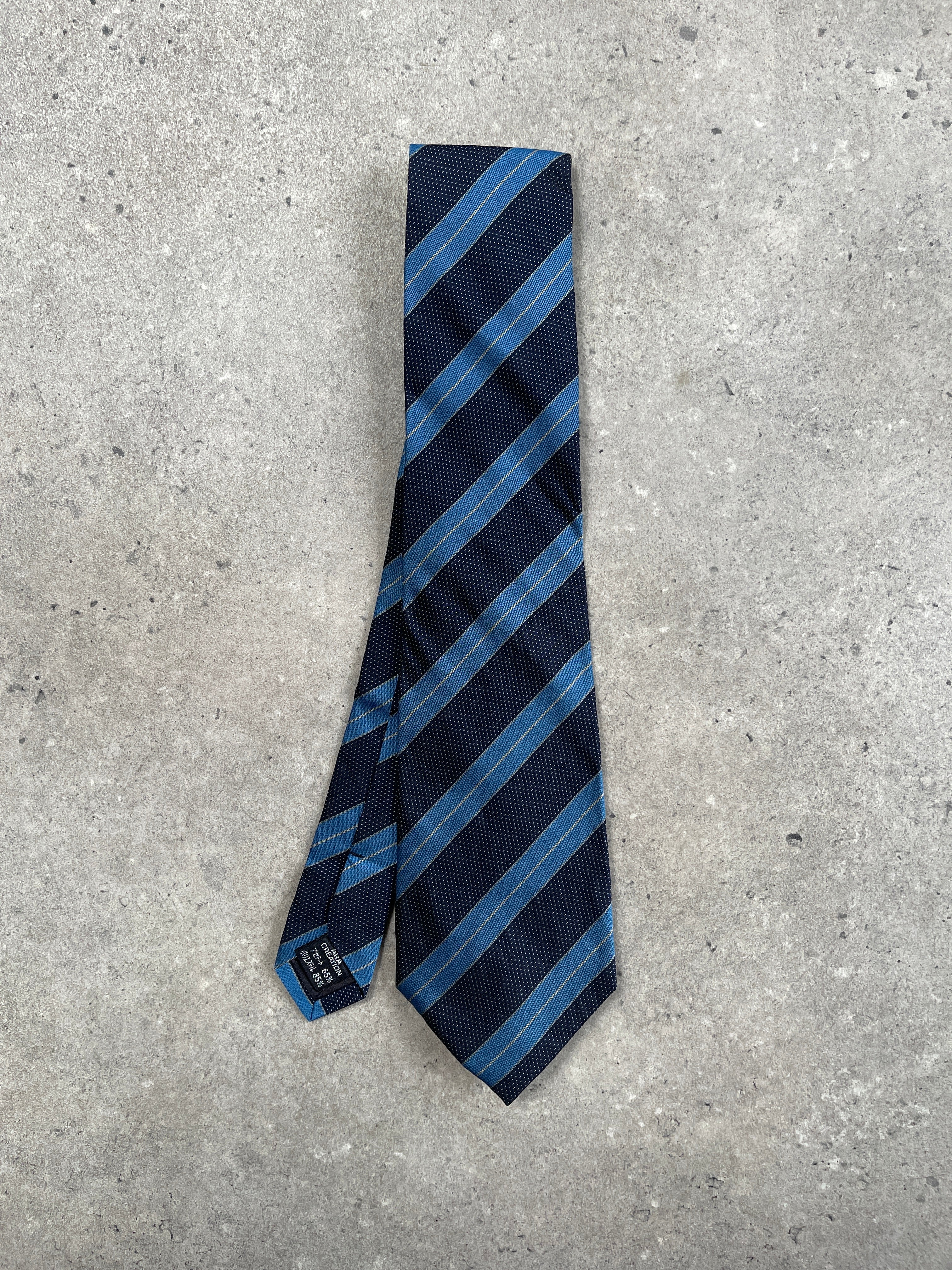 Calvin Klein CK 1990s diagonal stripe tie with navy and white pattern, classic silk fabric, versatile accessory for formal wear.