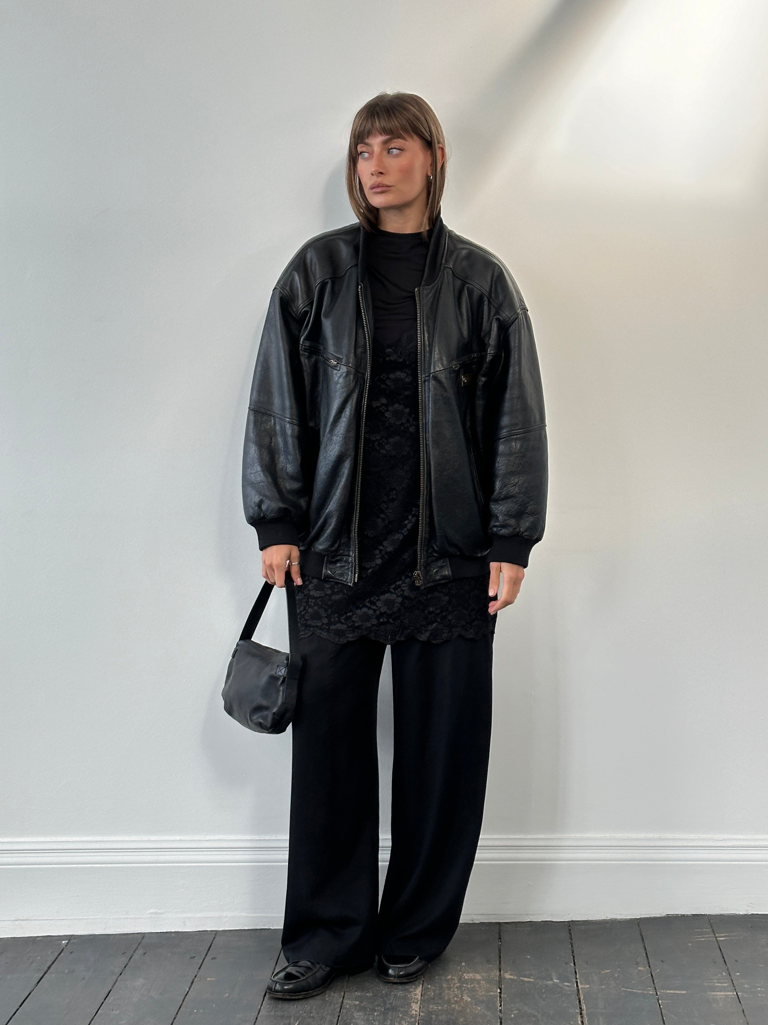 Vintage BMW 1990s leather bomber jacket in XL, featuring classic design, brown leather exterior, and ribbed cuffs.