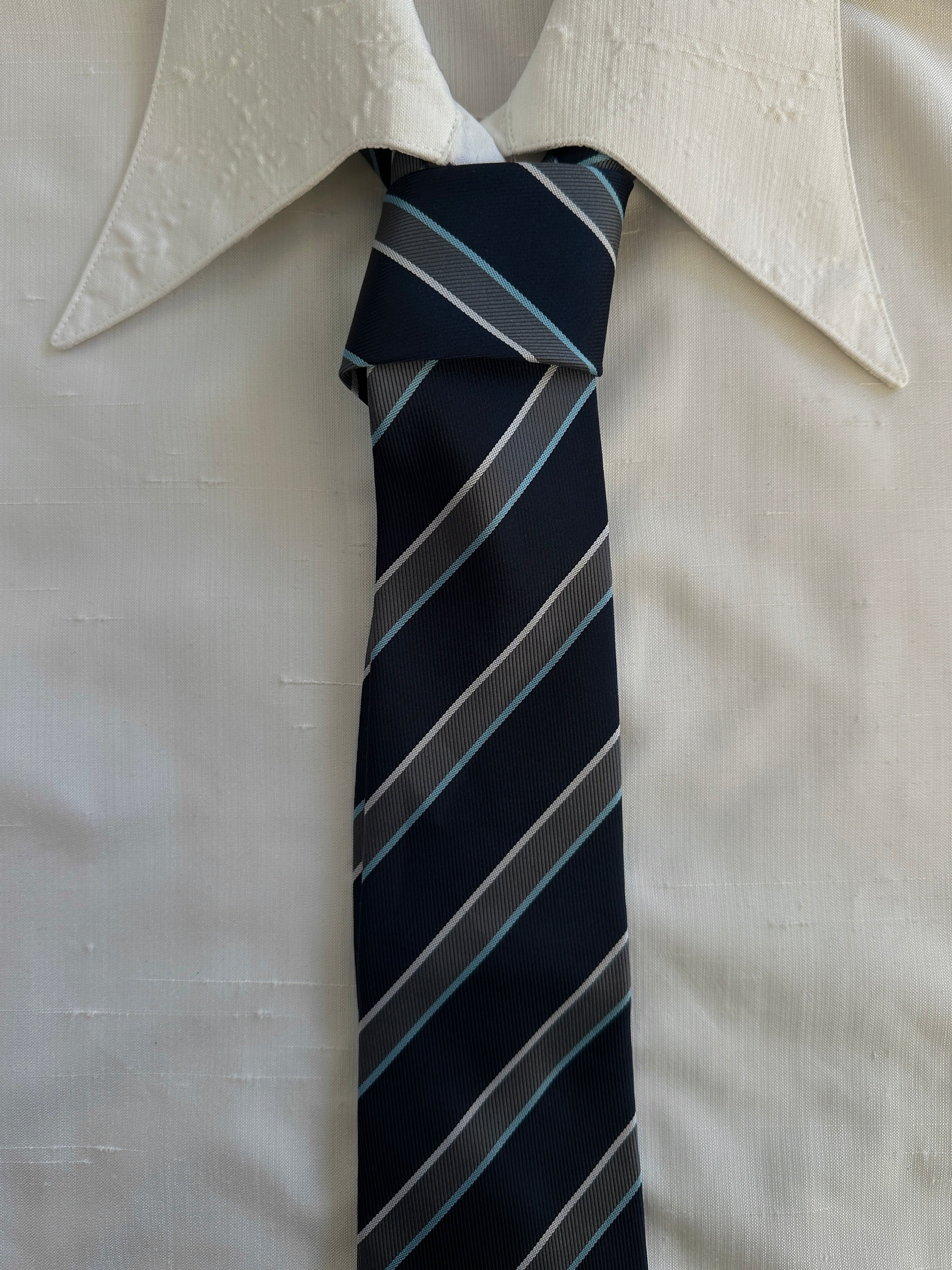 Vintage 1990s diagonal striped tie featuring bold multicolor pattern, made by Vintage, perfect for classic men's fashion.