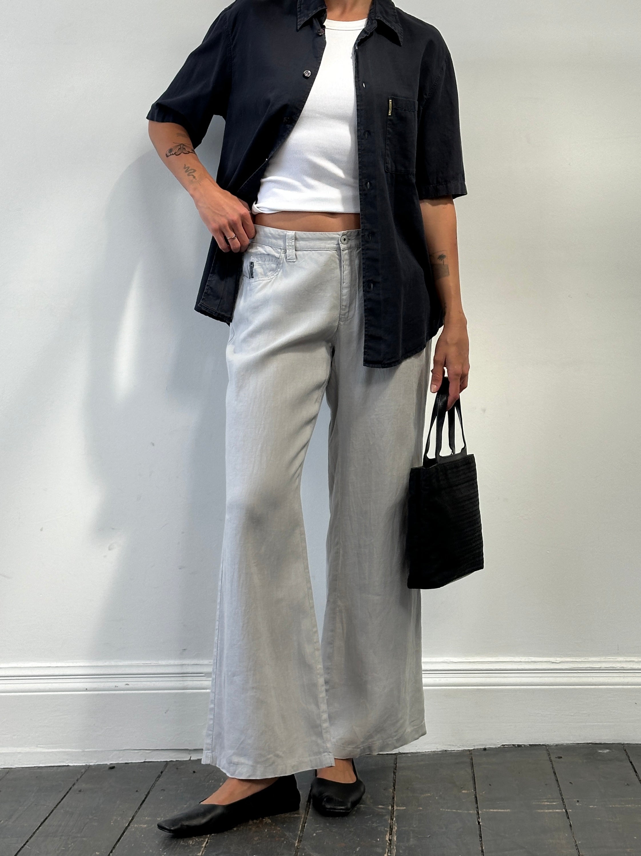 Armani Jeans pure linen flared trousers in size W33, showing the lightweight fabric and stylish fit on a neutral background.