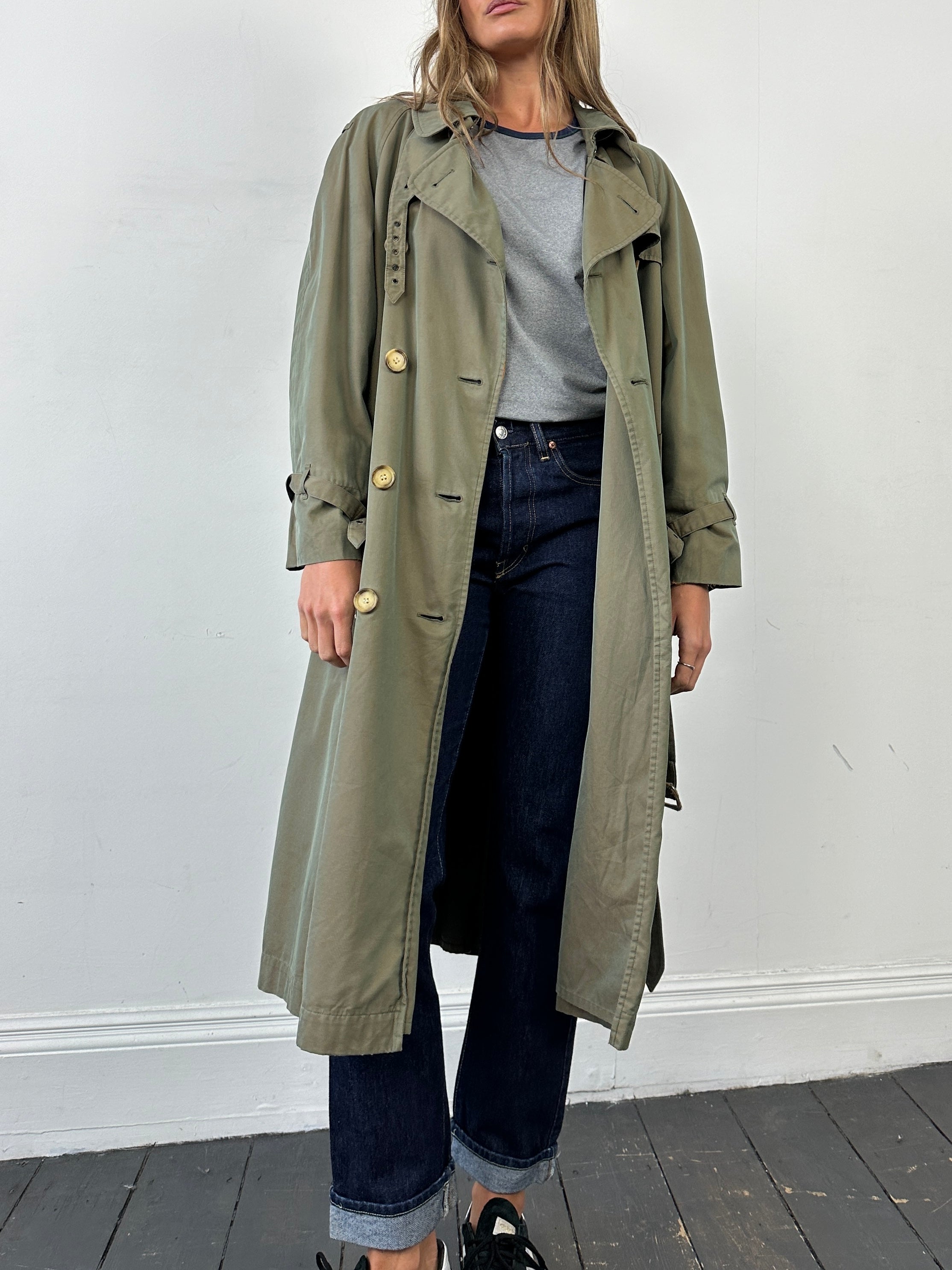 Yves Saint Laurent Rive Gauche 1980s double-breasted trench coat in beige, classic mid-length design, front view.