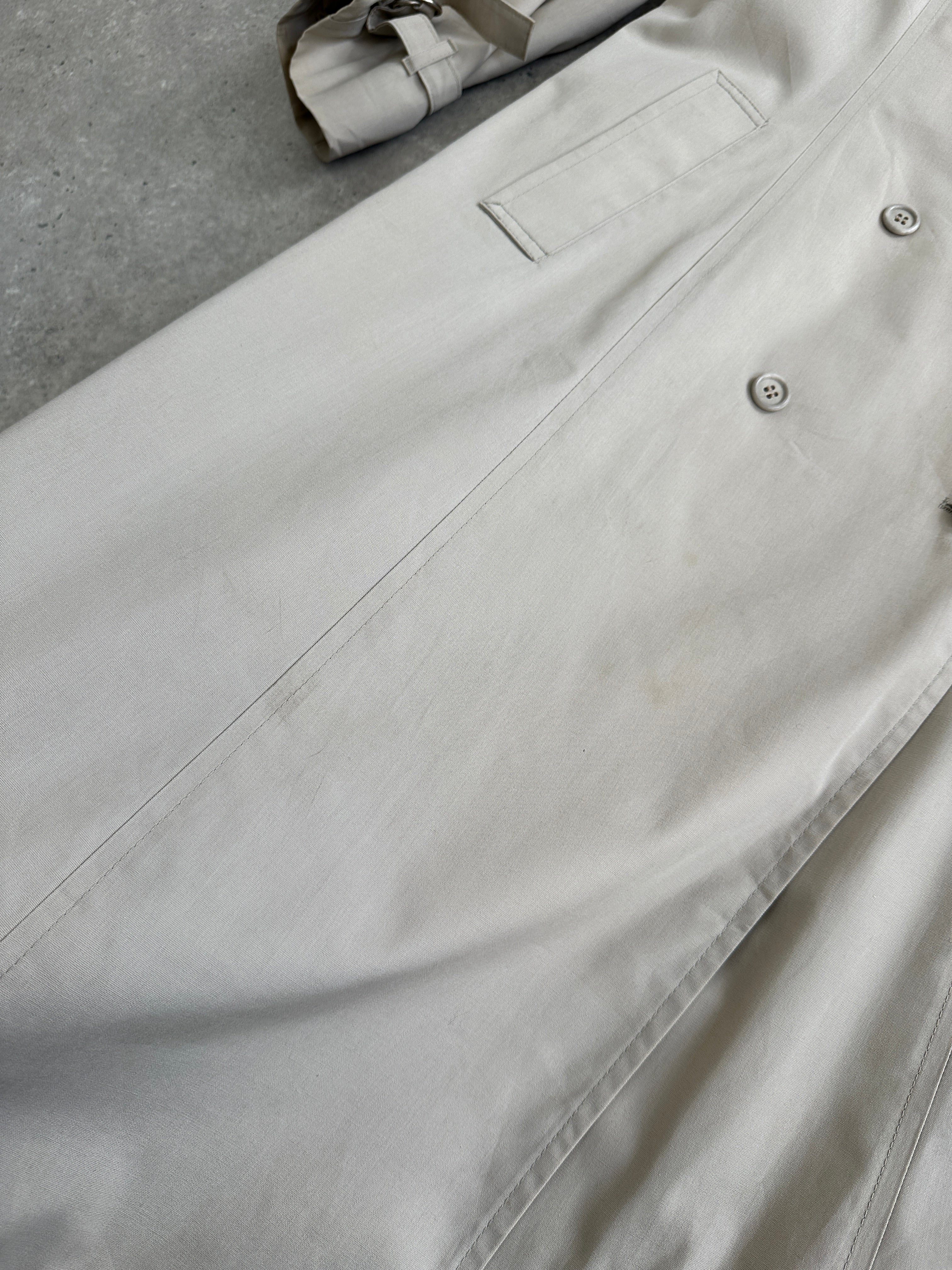 London Fog 1990s double-breasted cotton trench coat, mid-length, classic beige color, shown on a hanger.