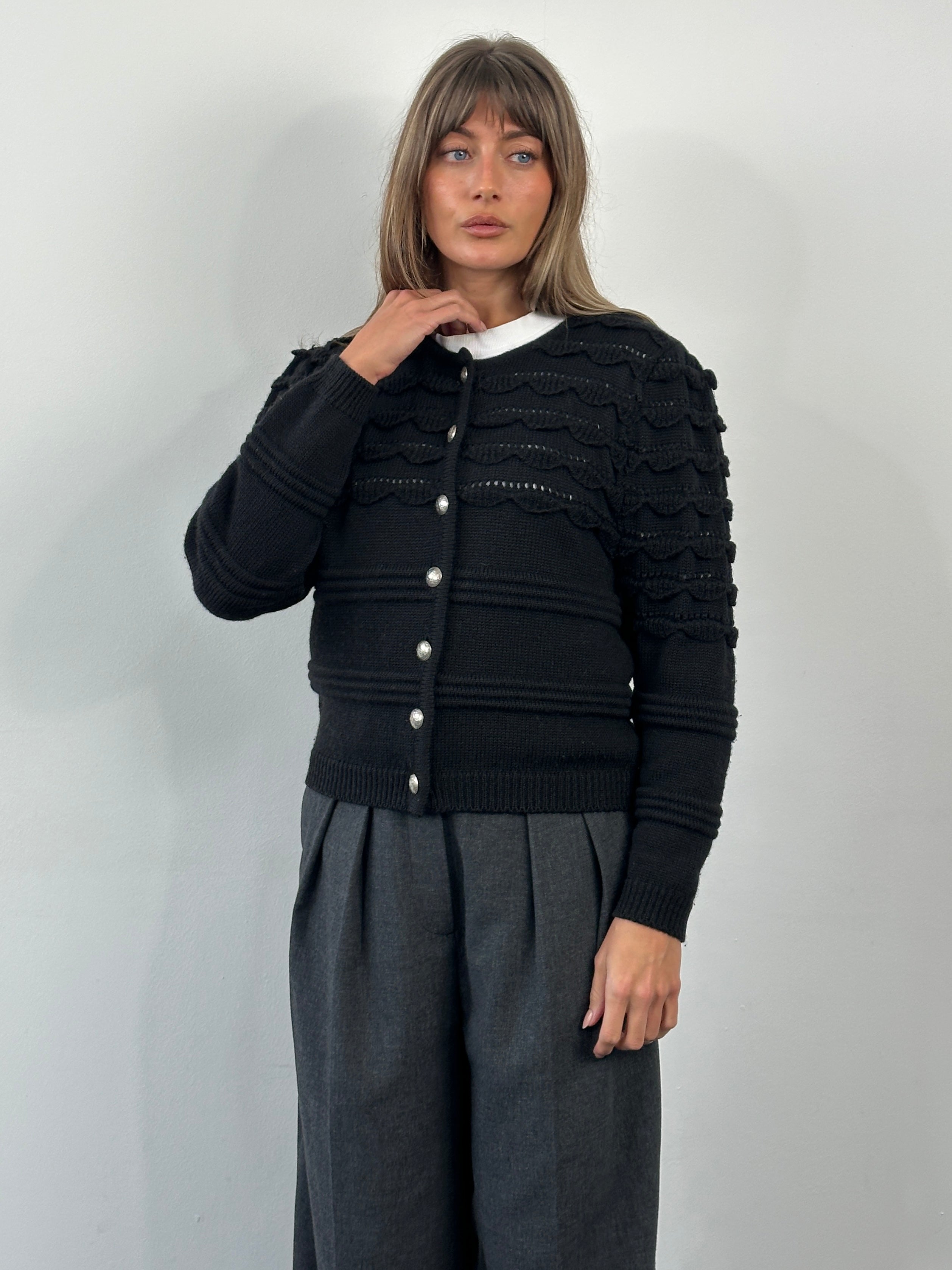 Vintage 1990s pure wool knitted cardigan, size M, featuring a classic design with button closures and textured knit pattern.