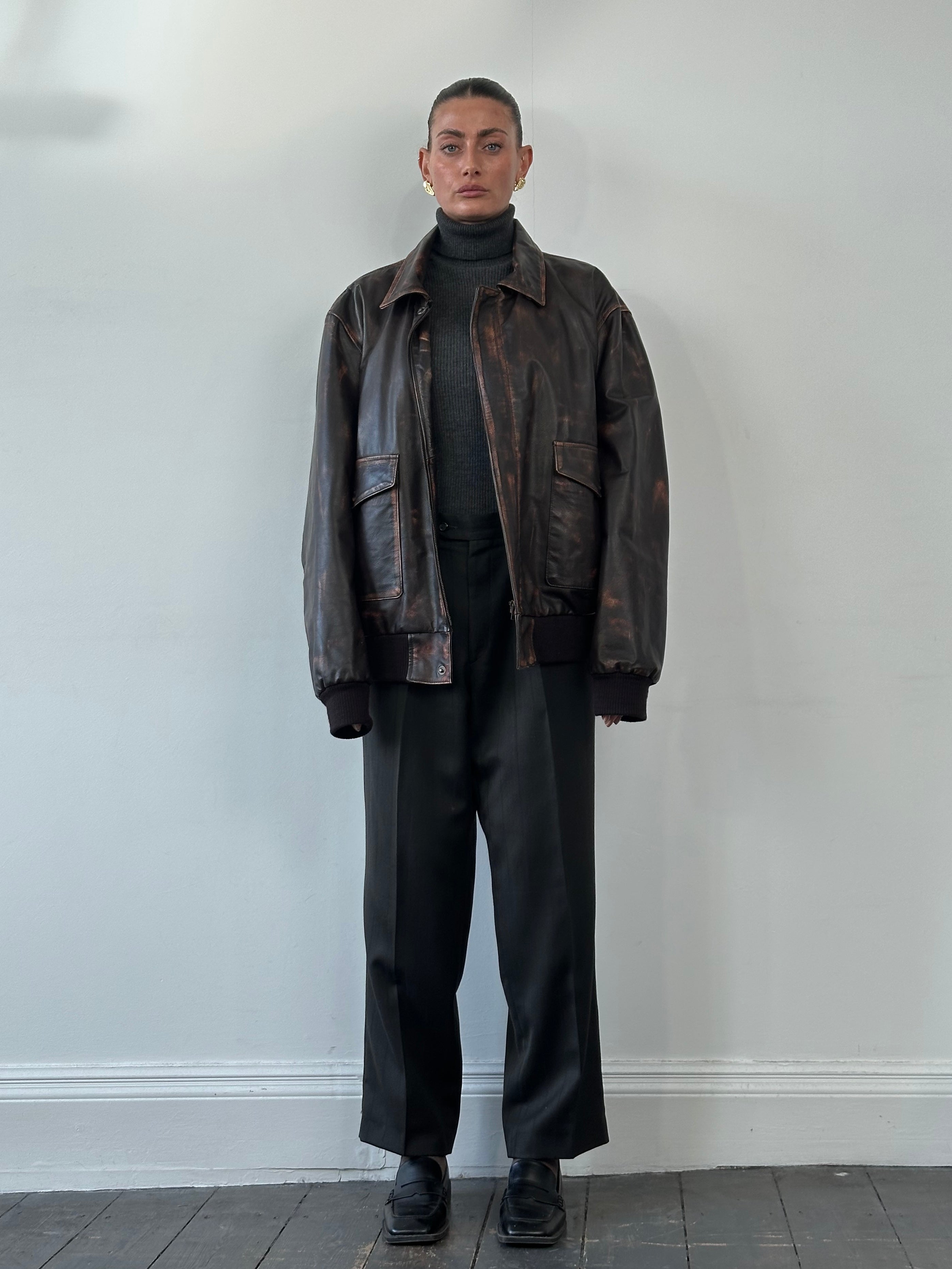 Vintage distressed leather jacket in XL size, featuring a rugged, worn-in look with classic styling and detailed stitching.