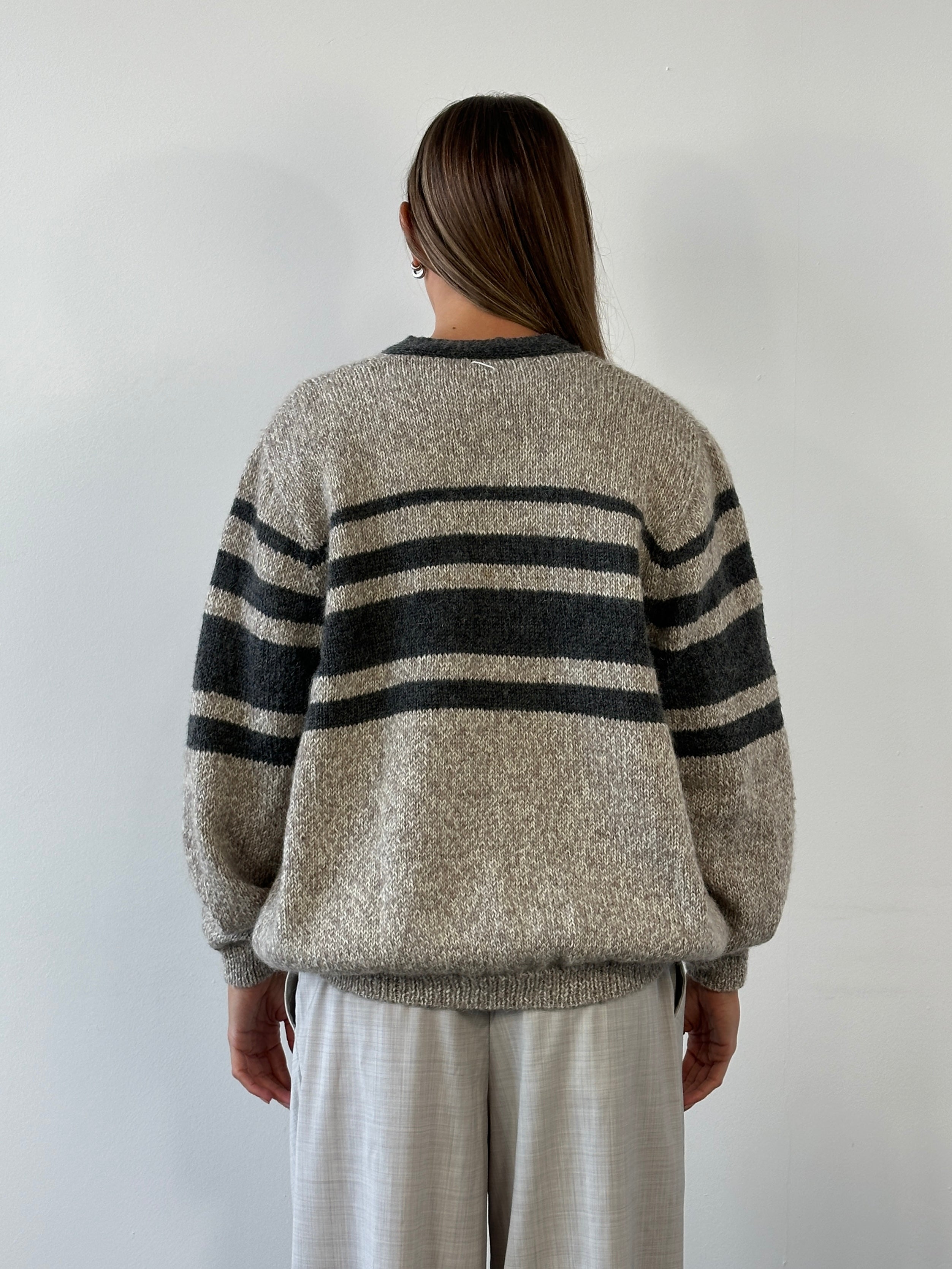 Vintage 1990s pure wool knitted striped cardigan in size L/XL, featuring classic multicolor pattern and cozy, textured fabric.