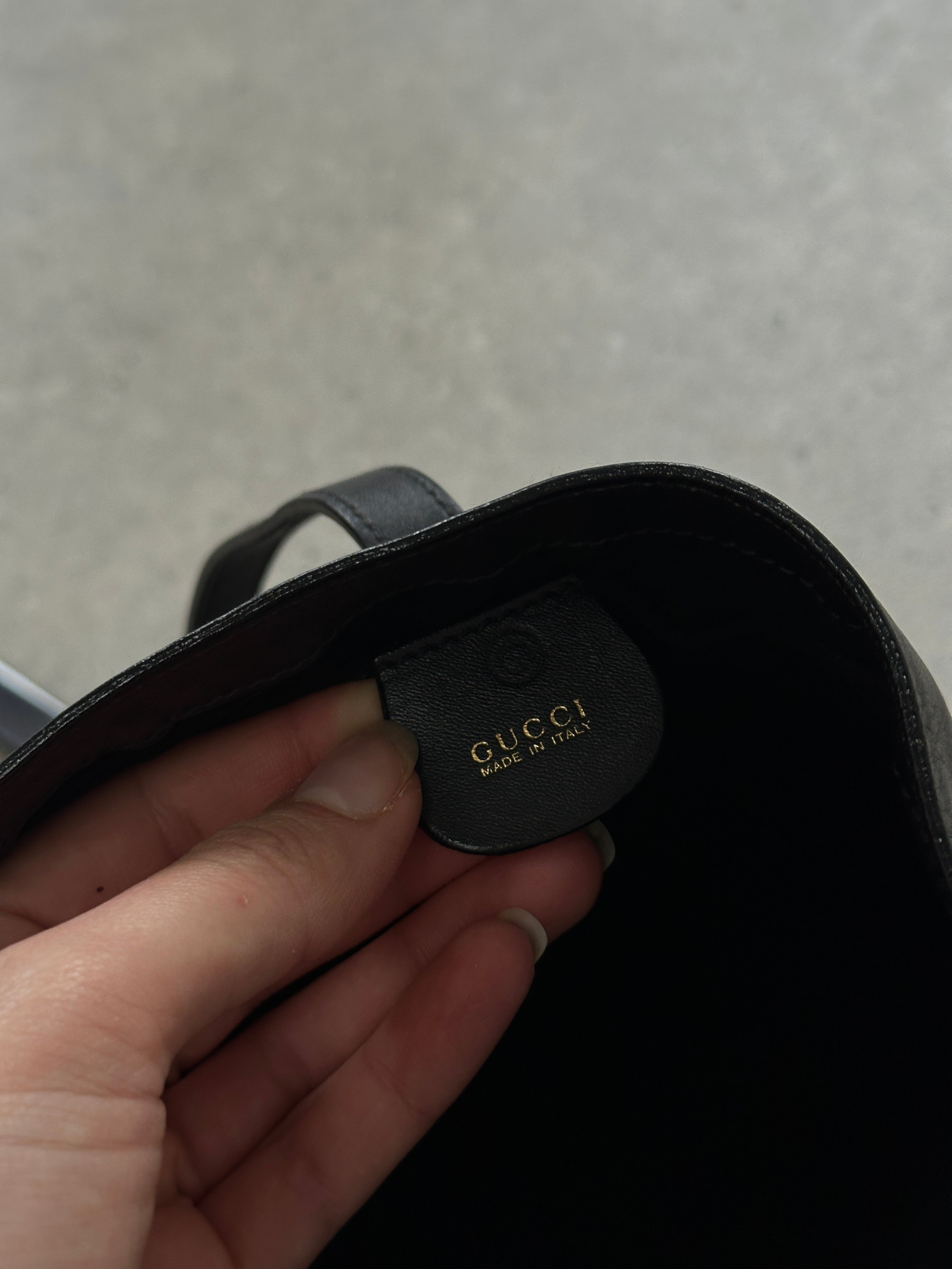 Gucci minimal rectangle leather bag with sleek design and top handle, featuring signature Gucci branding and smooth leather finish.