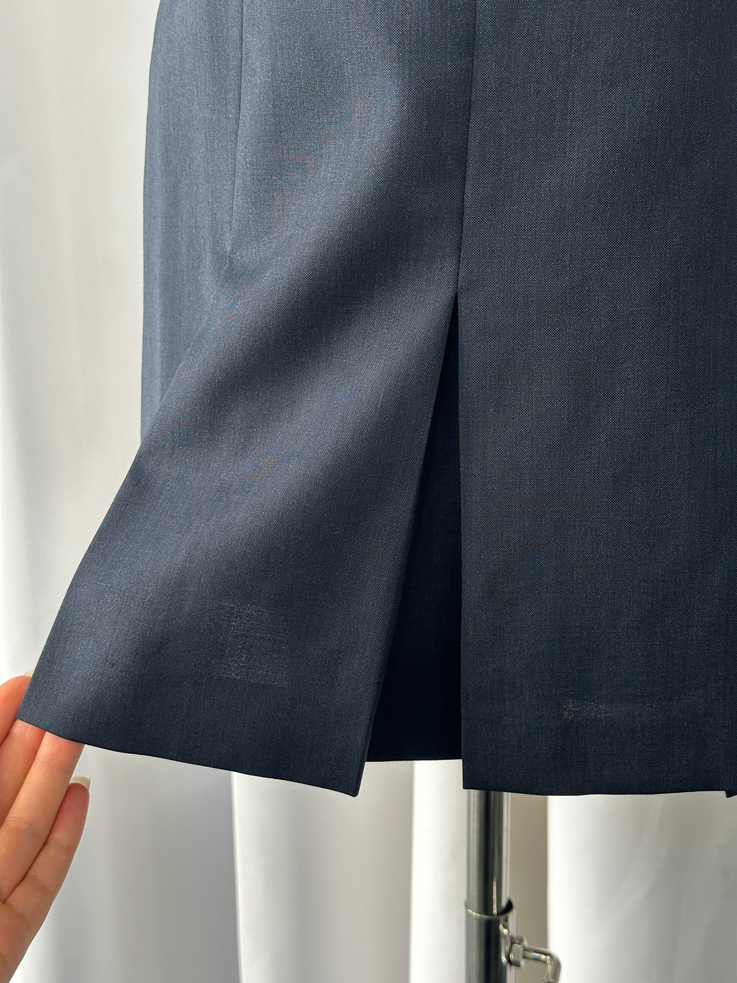 Vintage Italian 1990s pure Merino wool pleated mini skirt, W24, with a classic pleated design and wool texture.